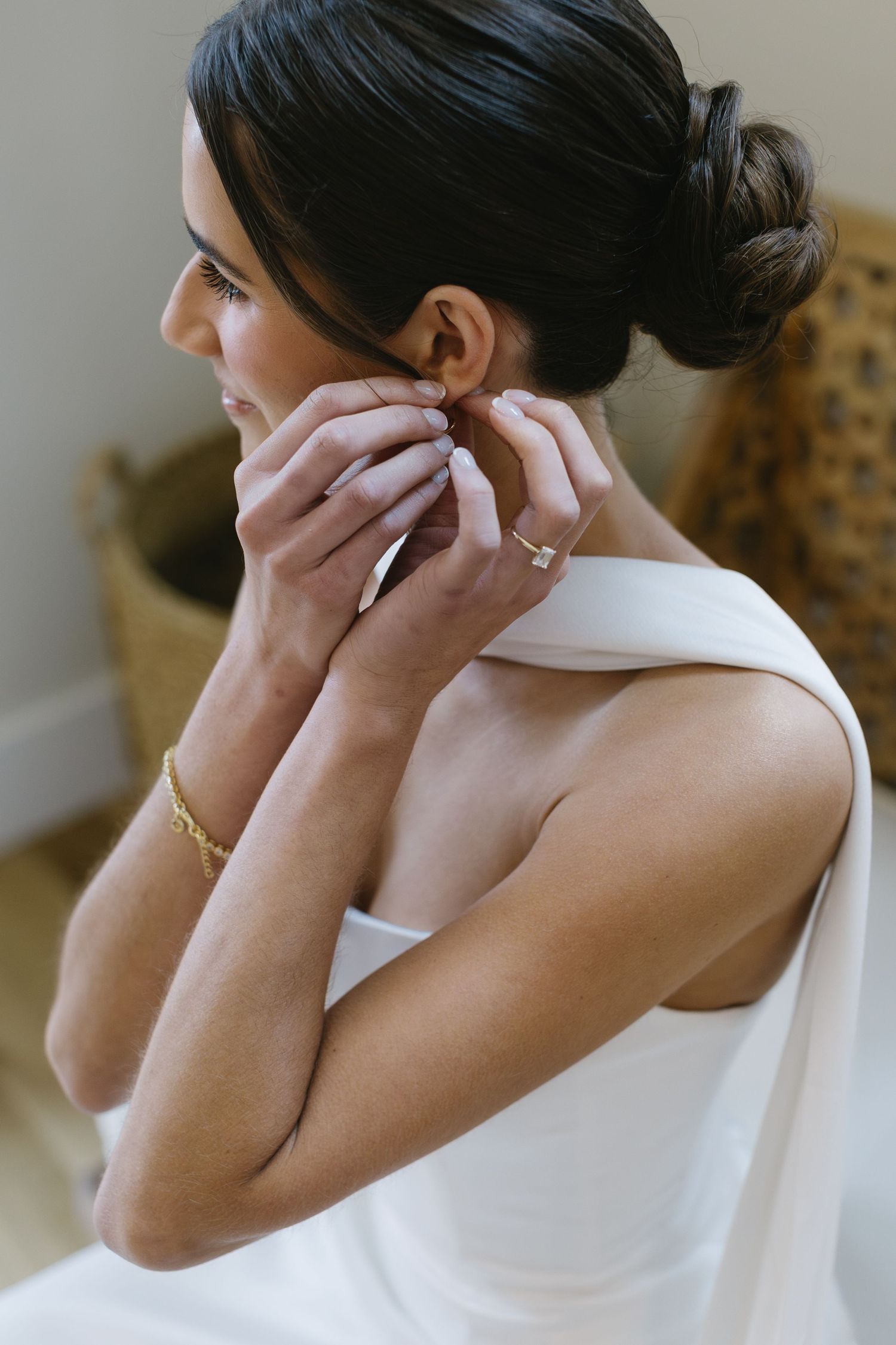 Close-up shots of a bride putting on delicate earrings during wedding preparations.