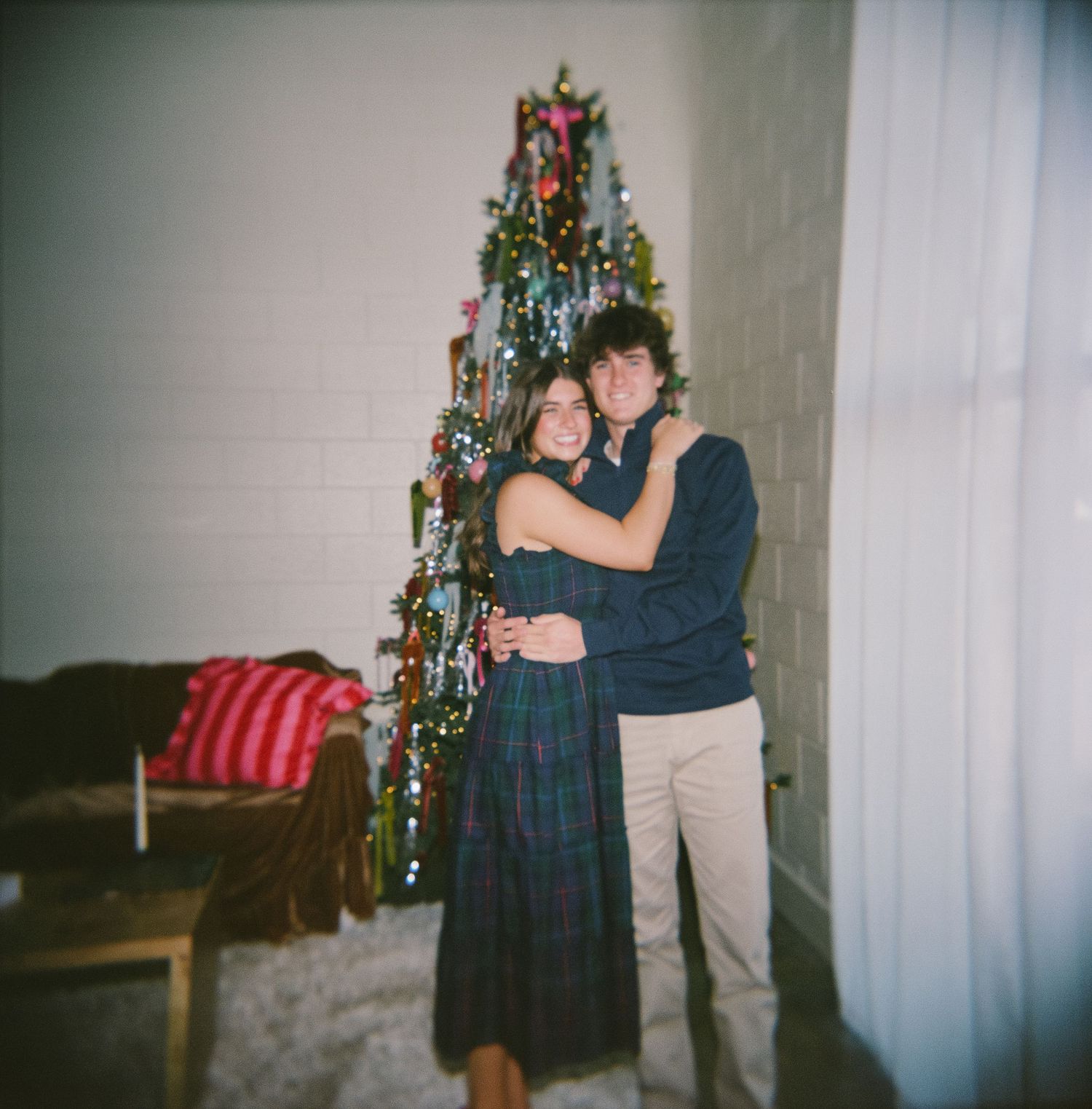 A series of vintage-style photos showing two people dancing and embracing near a decorated Christmas tree in a living room.