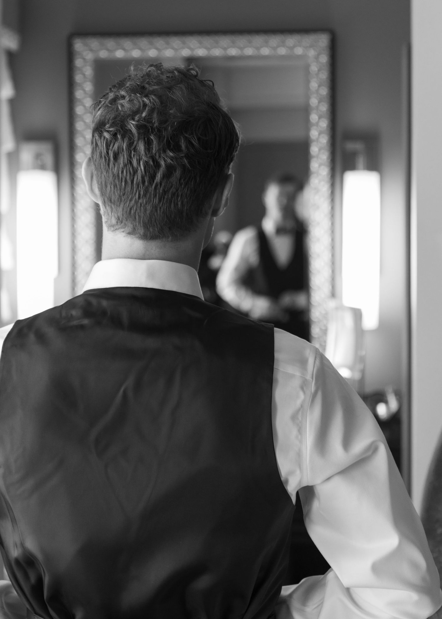 Back view of formal wedding attire in black and white tones.