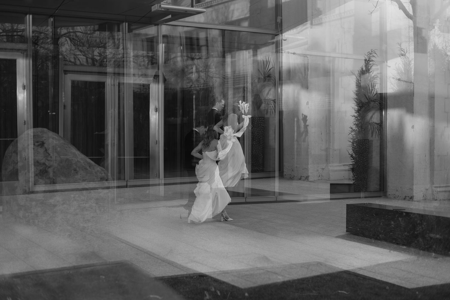 Series of artistic black and white reflections showing wedding couple through glass windows.