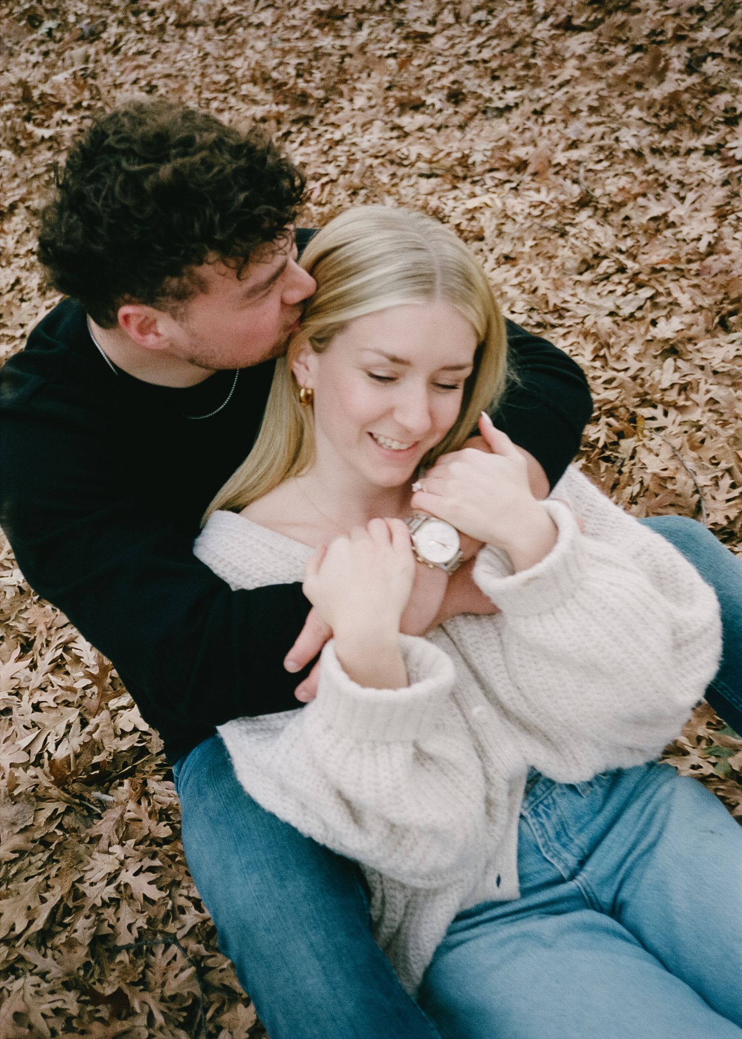 A tender moment captured among autumn leaves.