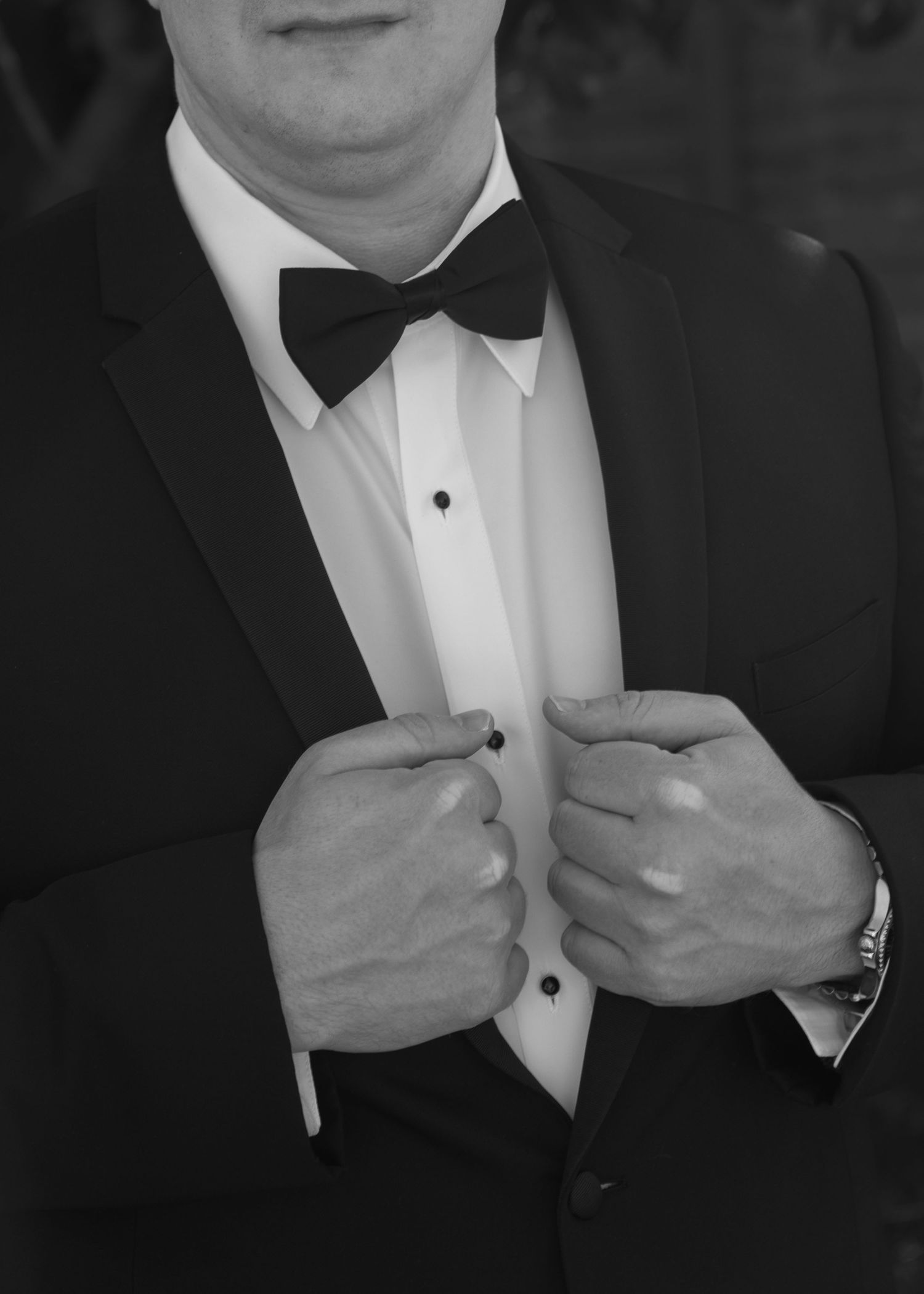 Close-up of formal black bow tie and tuxedo adjustments.