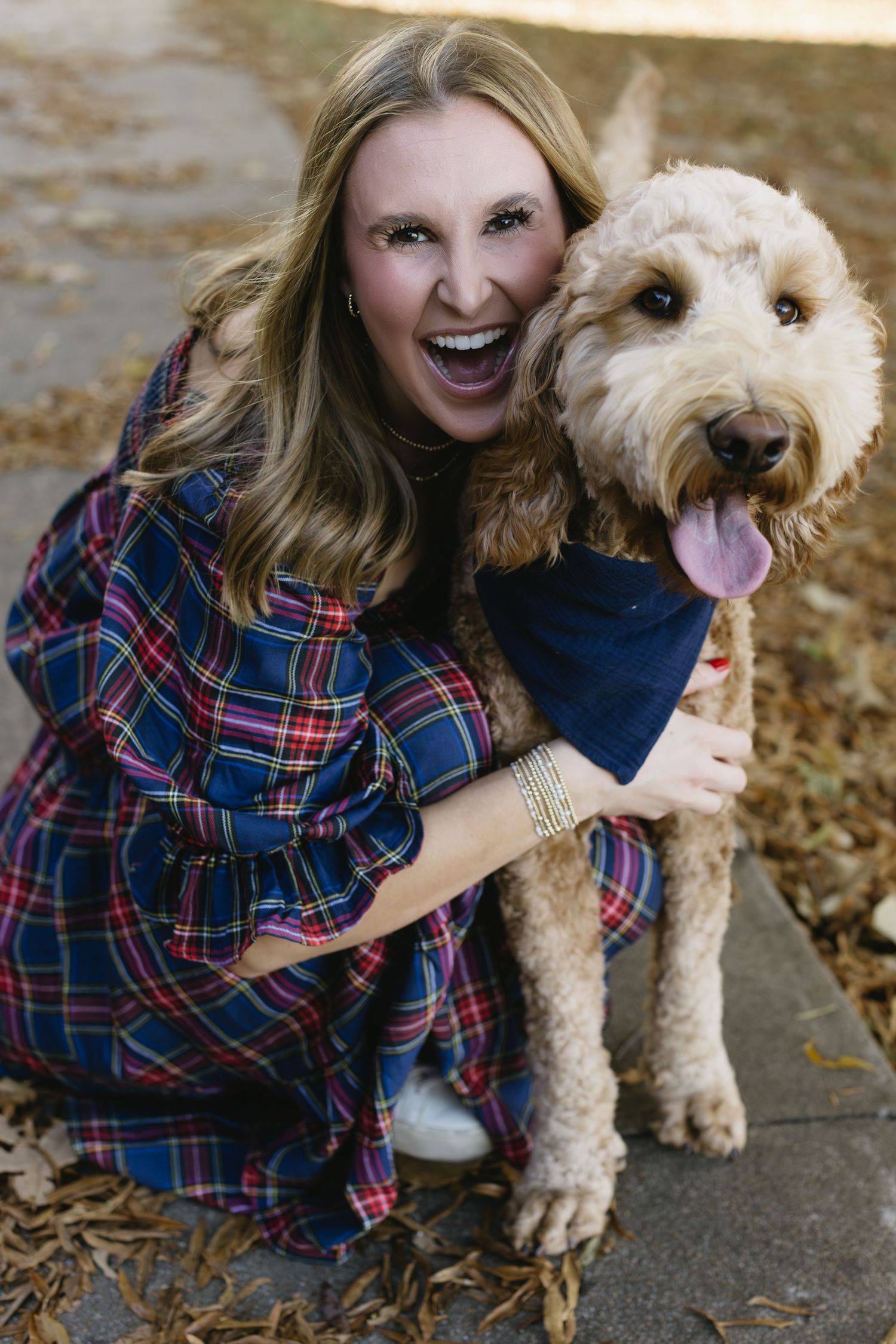 A playful series of photos with a goldendoodle dog showing affection outdoors.