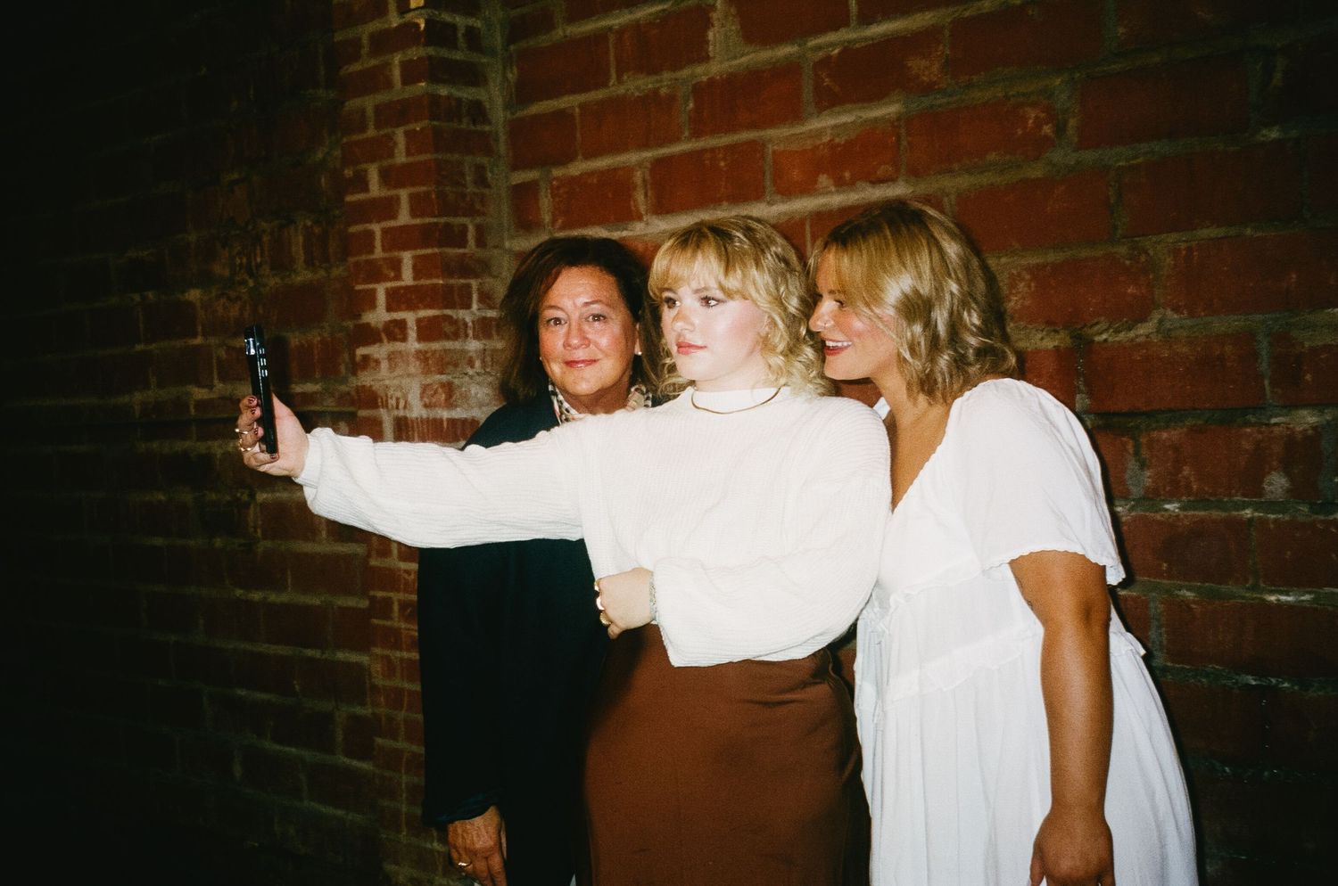 People in white outfits dancing and celebrating at a party.