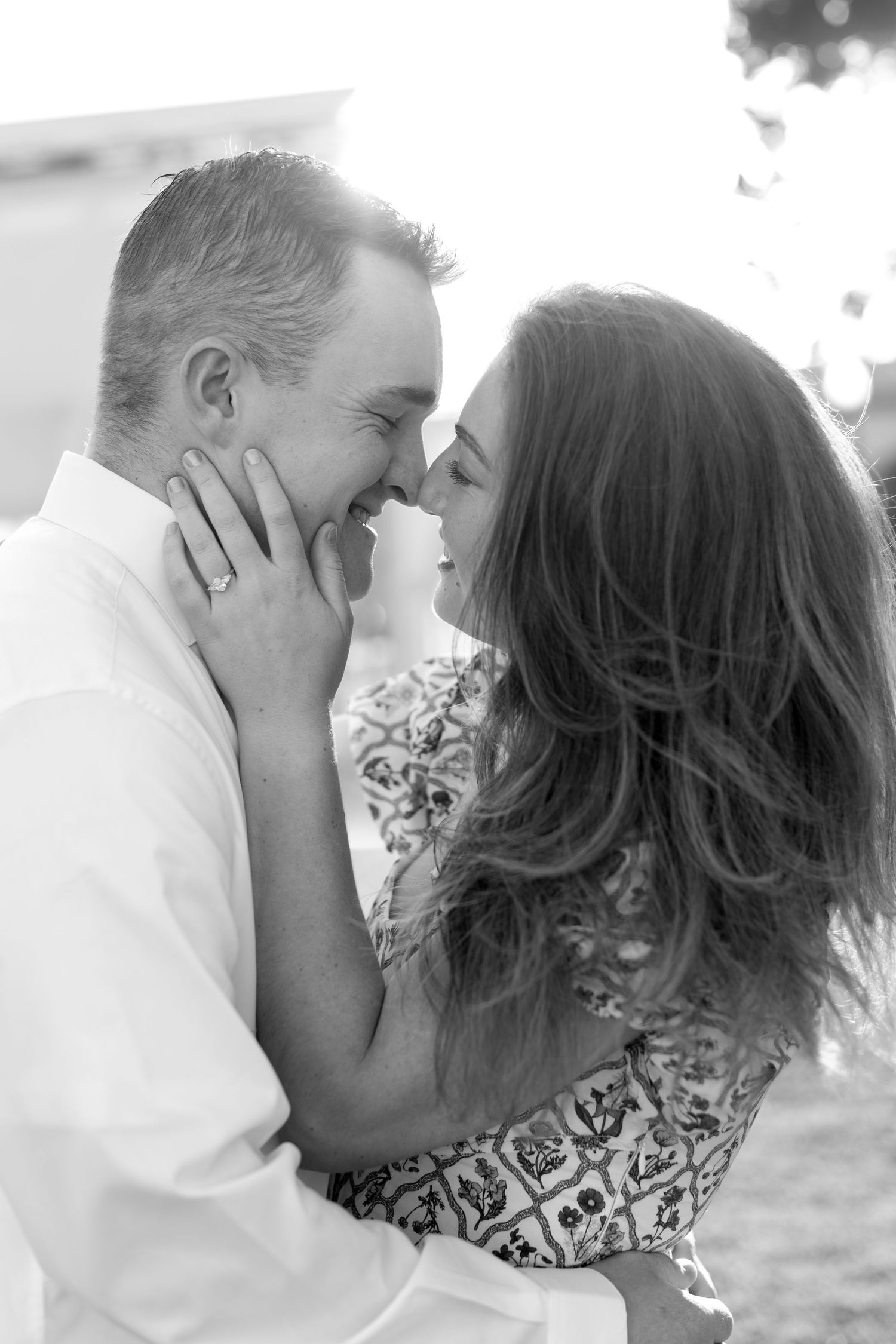 Black and white romantic portraits of a couple sharing intimate moments outdoors.