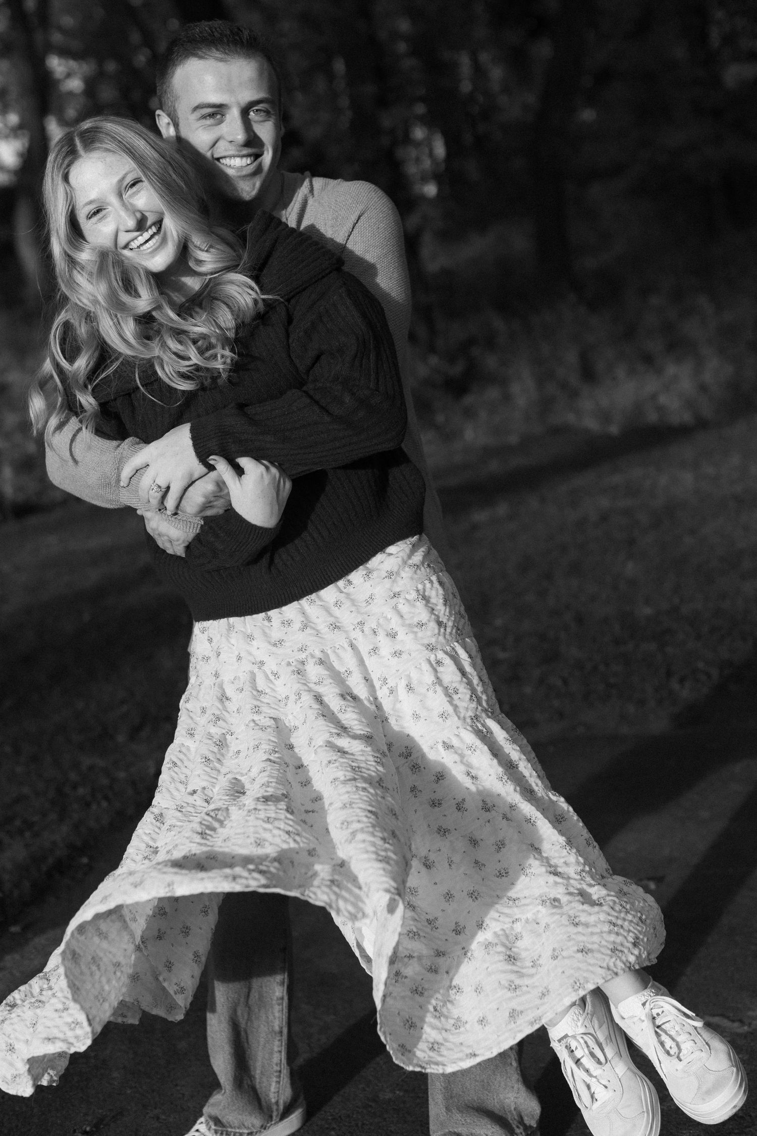 A romantic black and white photo sequence showing a couple dancing and twirling in a flowing white dress.