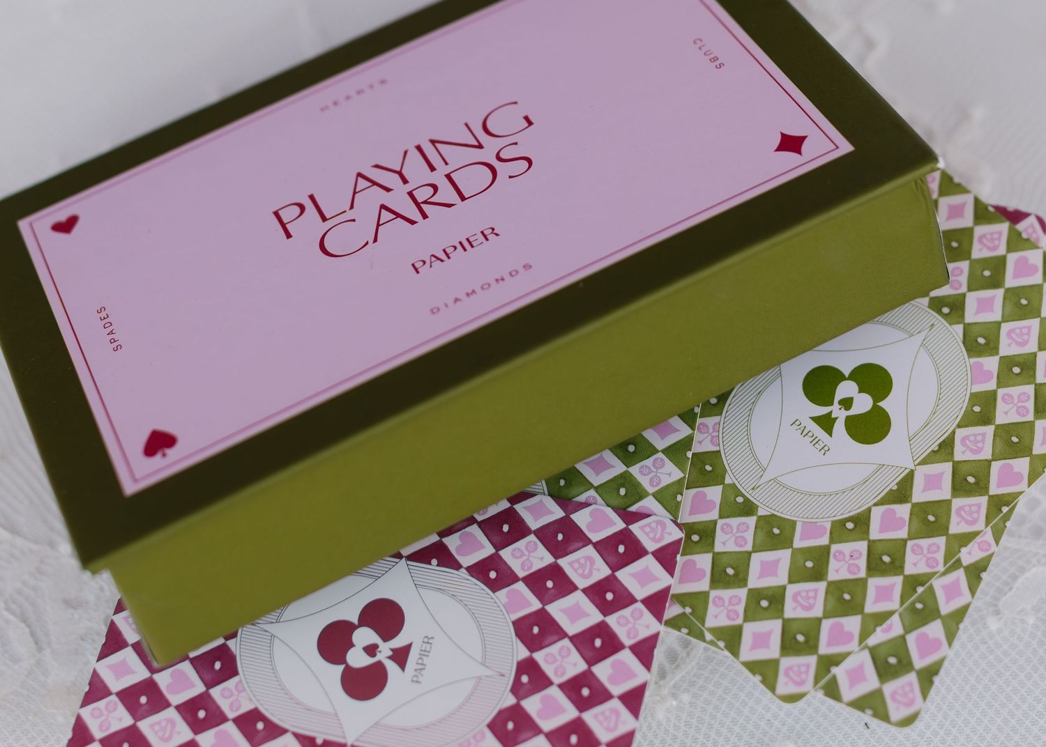 Pink and green patterned wedding cards with heart designs arranged in a row.