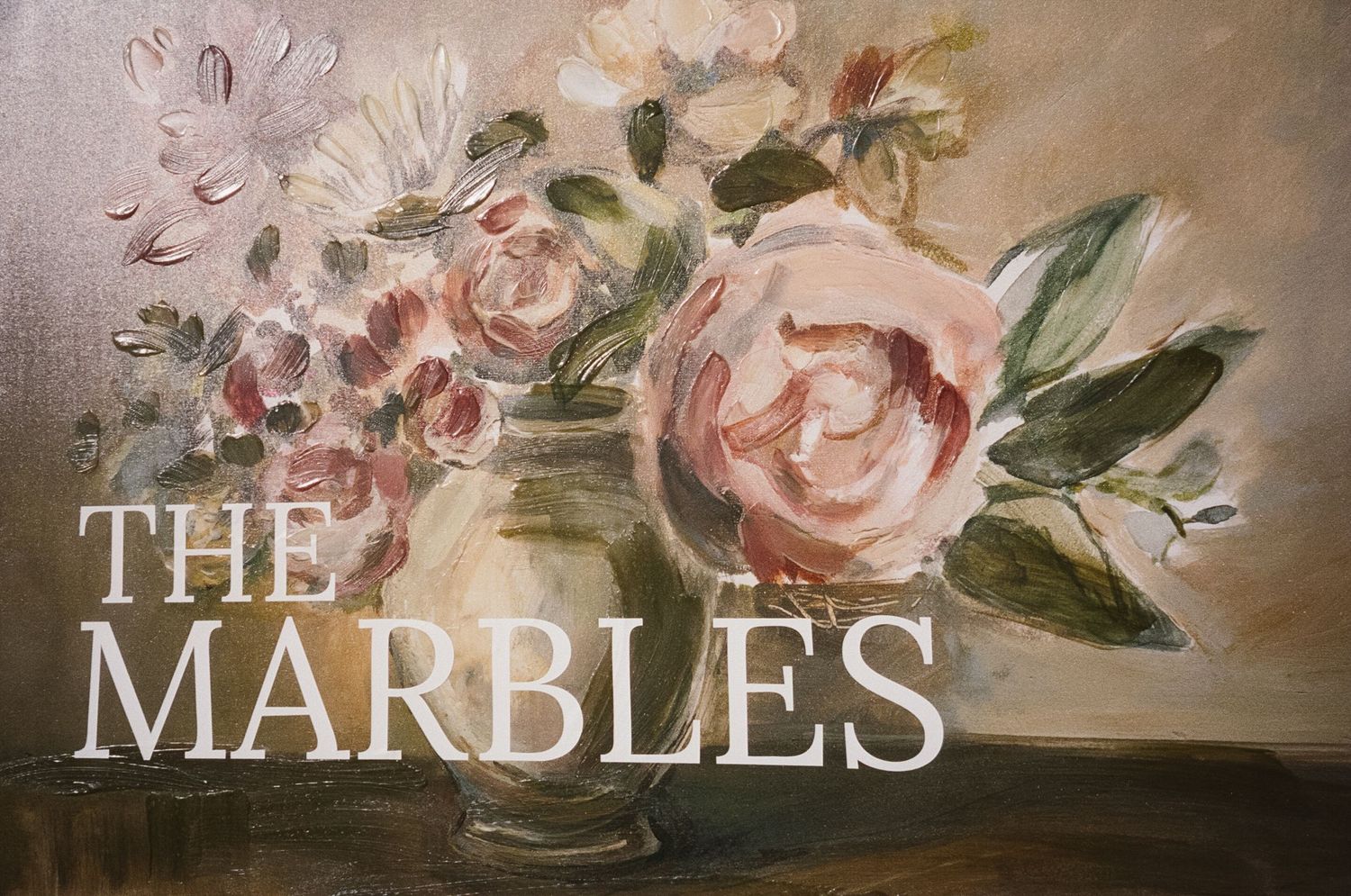Vintage-style floral mural with pink roses and text reading 'The Marbles'.
