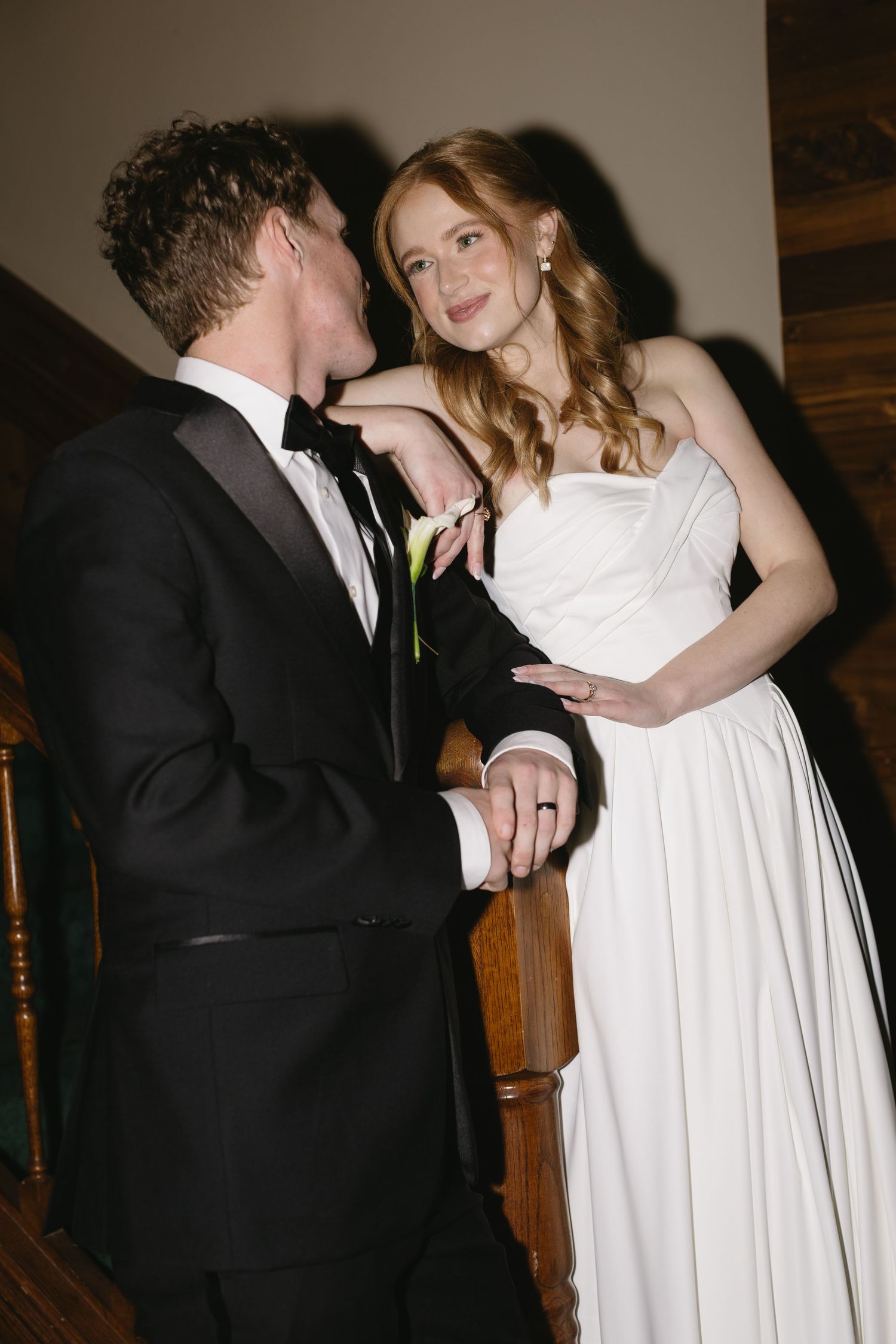 Romantic wedding couple dancing together in formal attire.
