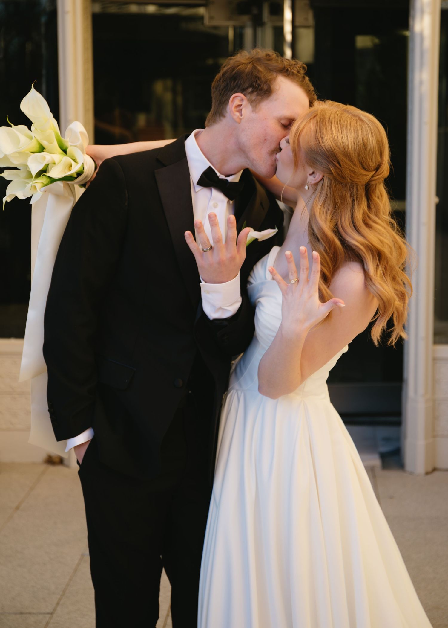 Romantic wedding couple sharing intimate moments in formal attire.