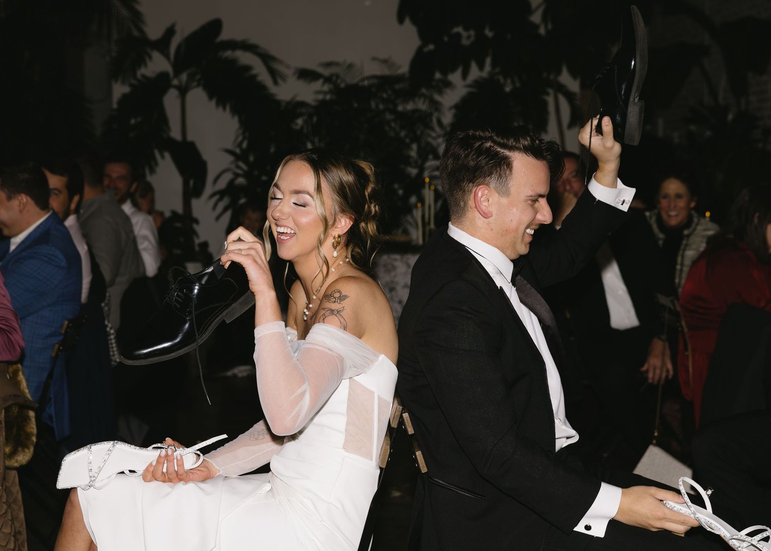 Wedding reception dance floor with guests in formal attire.