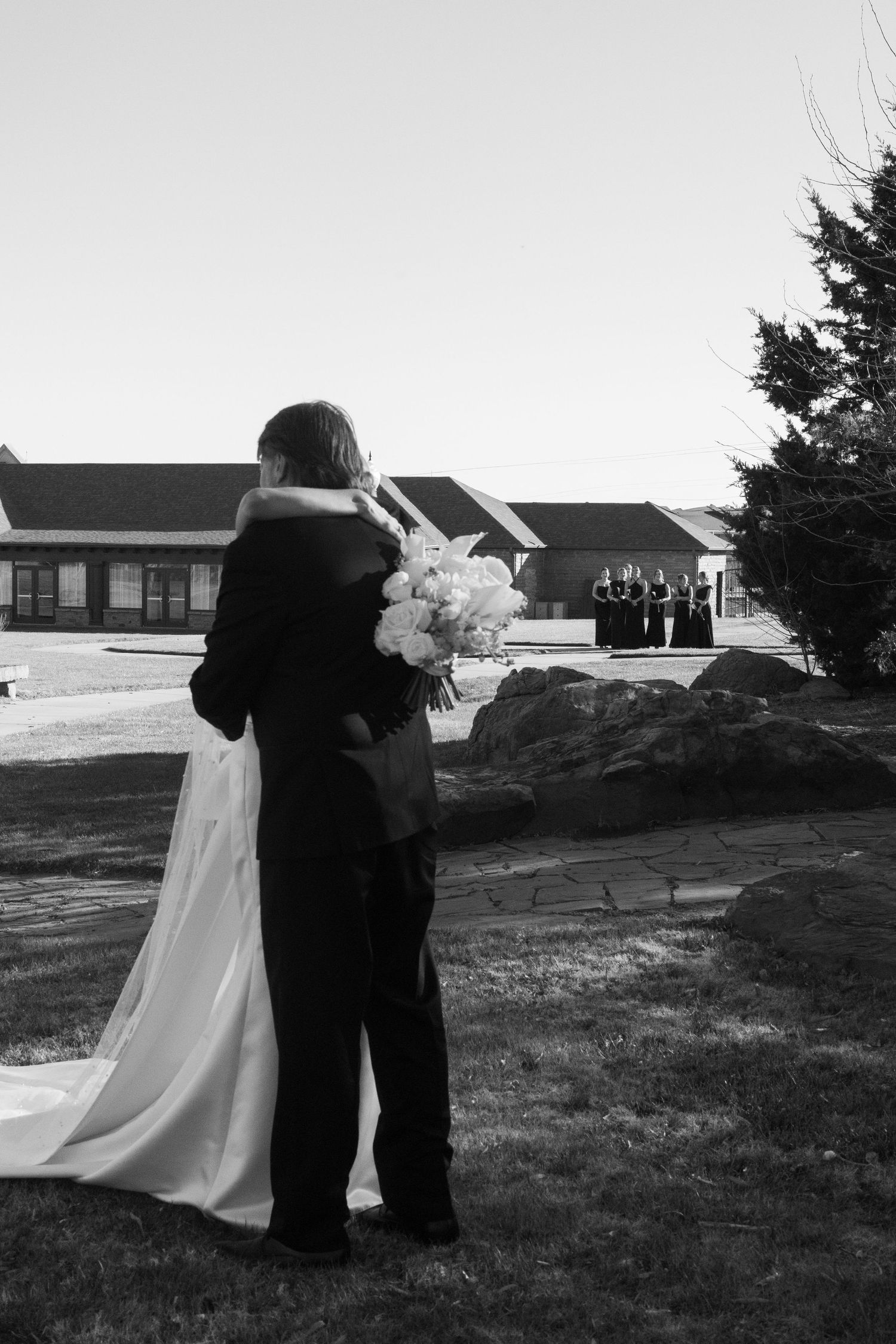A series of black and white wedding photos showing a couple walking together outdoors.