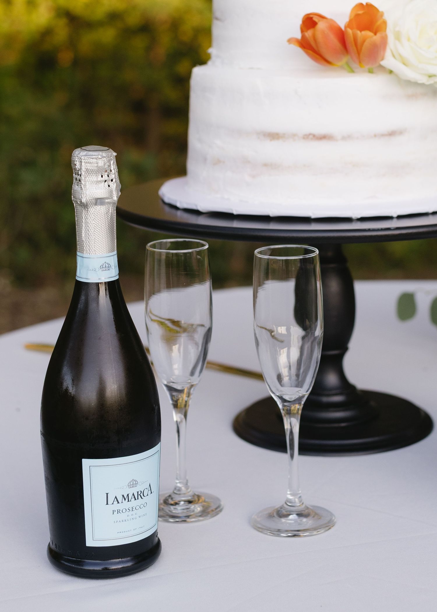 Wedding reception table with champagne bottles and elegant crystal glasses on display.