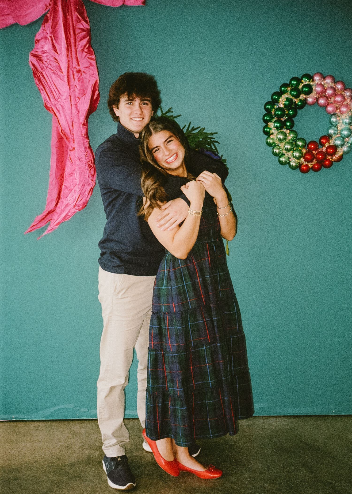A sequence of festive photos with pink decor and Christmas ornaments showing a couple dancing together.