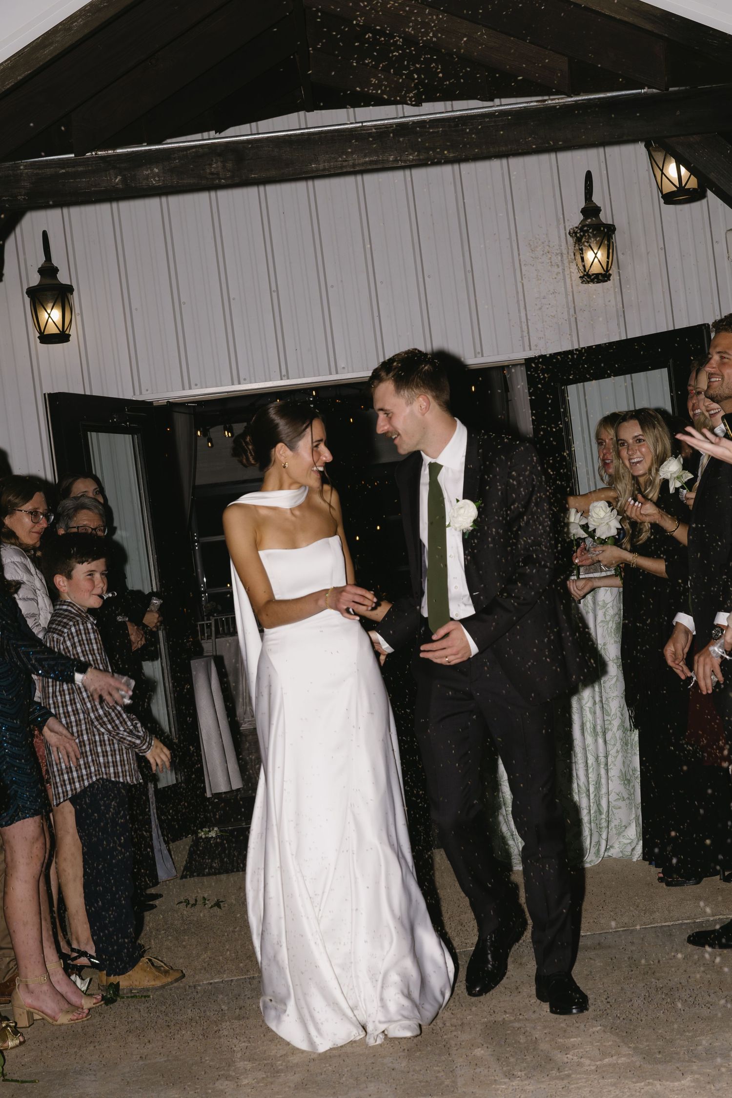 Wedding guests celebrate during the sparkler exit as newlyweds make their grand departure.