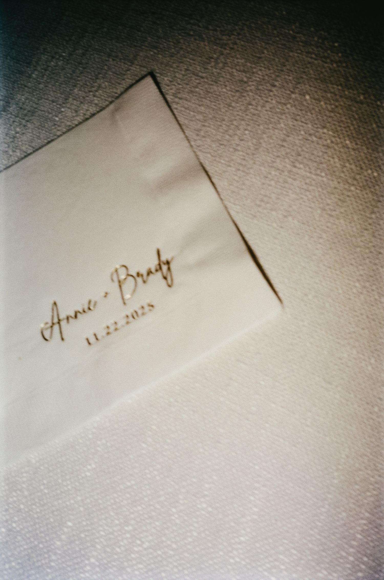 Close-up detail shot of handwritten wedding place cards on textured paper.