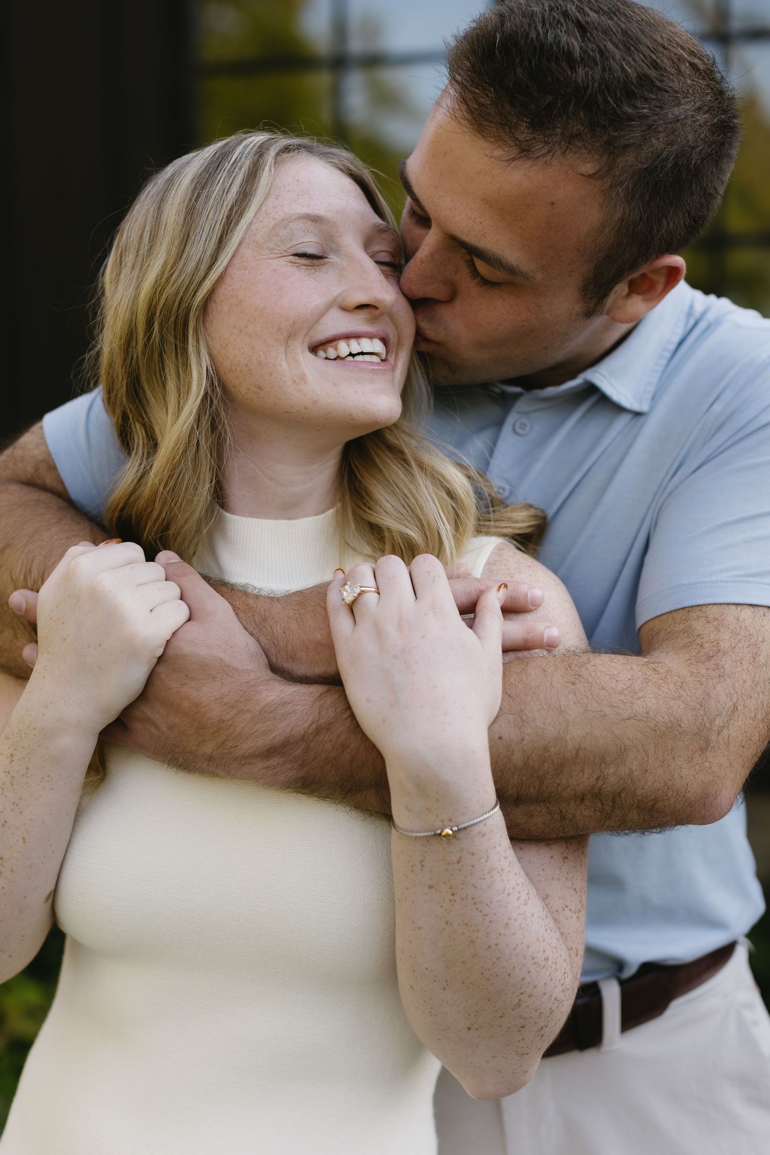 Close-up shots of a couple in light clothing sharing tender moments outdoors.