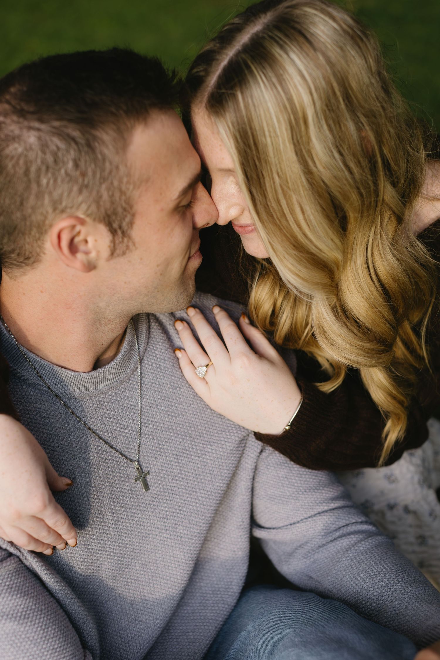 A romantic couple in matching gray sweaters share intimate moments in a series of close-up photographs.