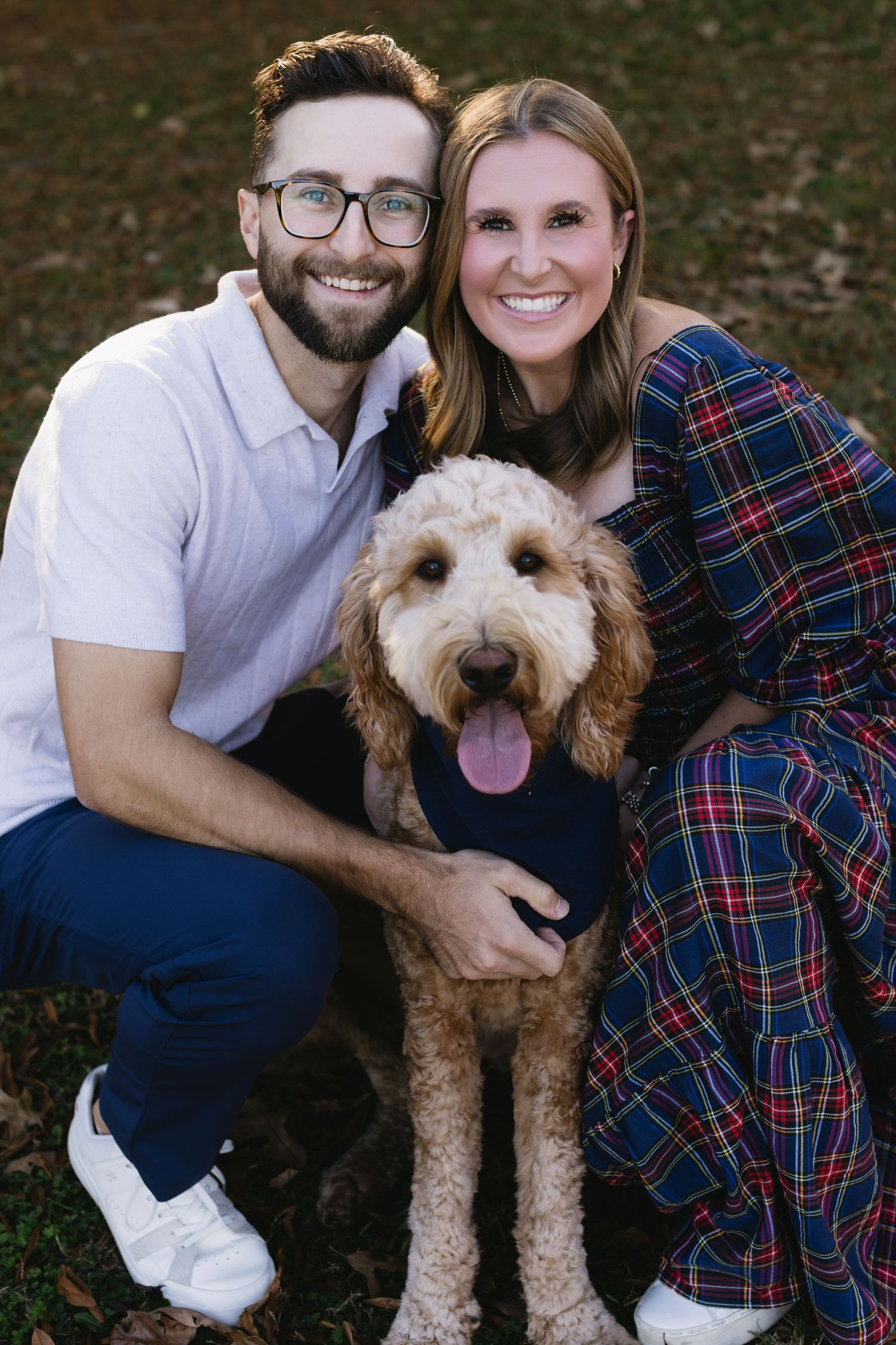 A series of casual outdoor portraits featuring a couple and their friendly goldendoodle dog.