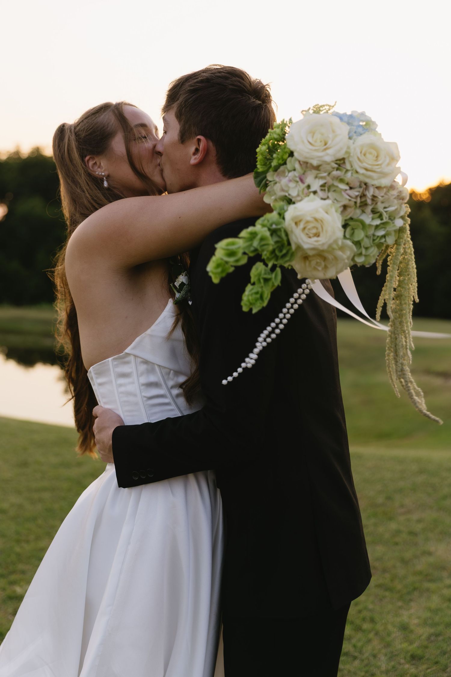Romantic sunset wedding portraits showing tender moments between the newlyweds.