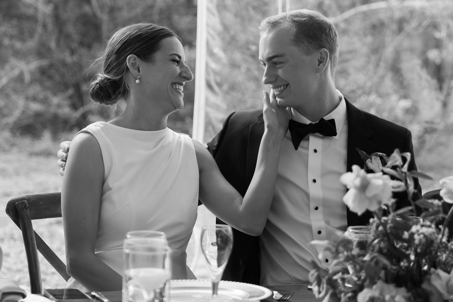 Black and white candid reception photos showing guests dining and conversing at outdoor venue tables.