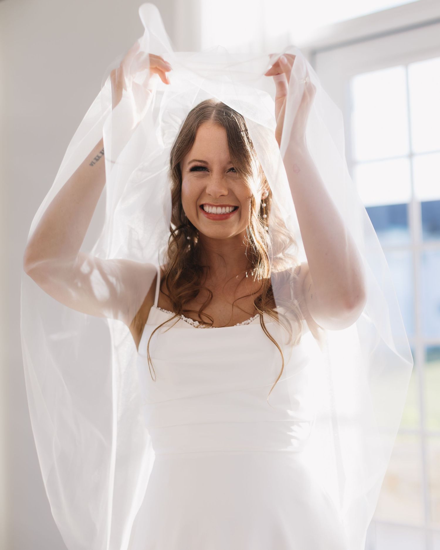 Sequence of closeup shots featuring a bride with a flowing veil indoors against bright natural lighting.