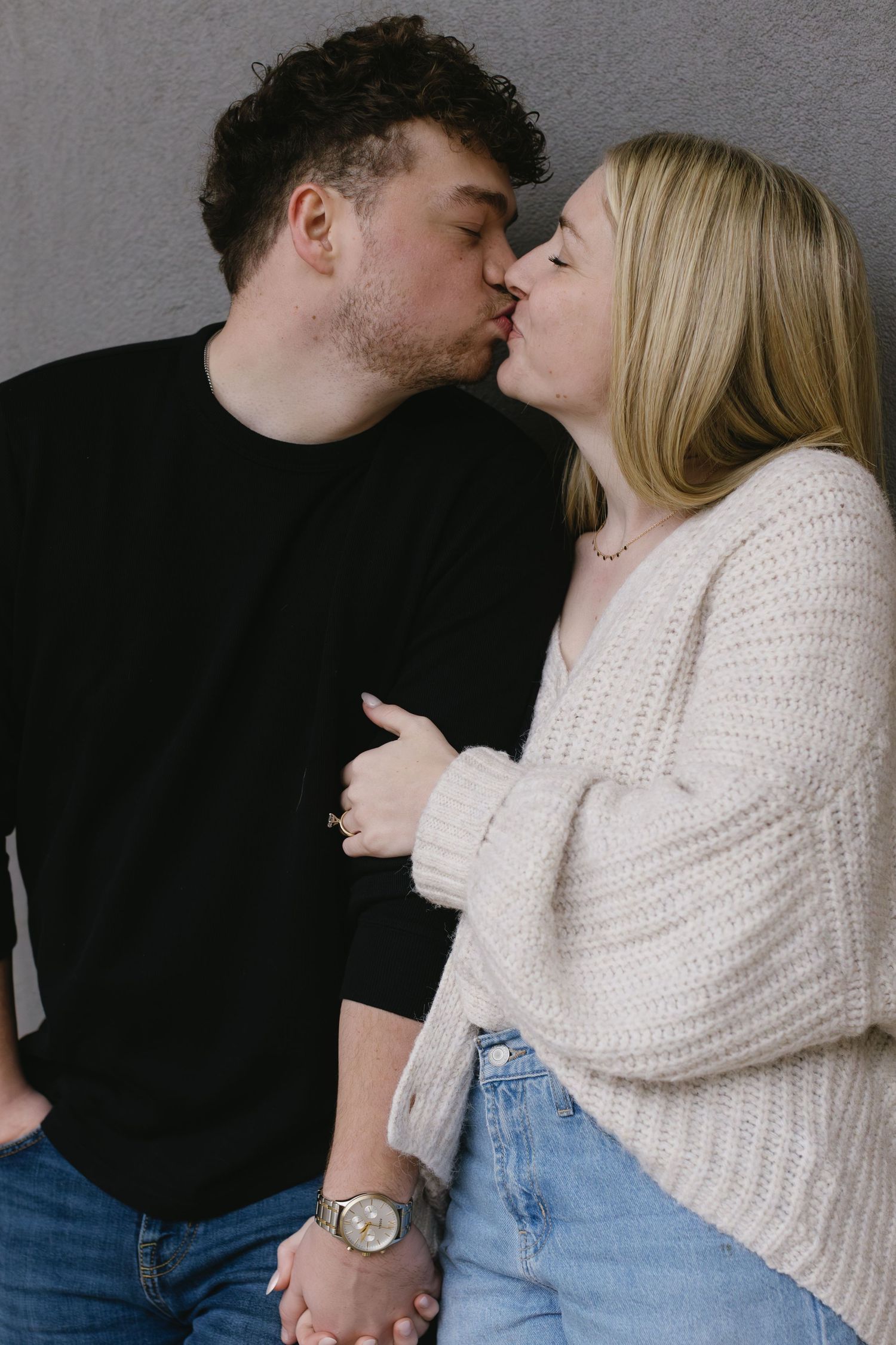 Intimate couple in casual attire sharing tender moments in a romantic photoshoot sequence.