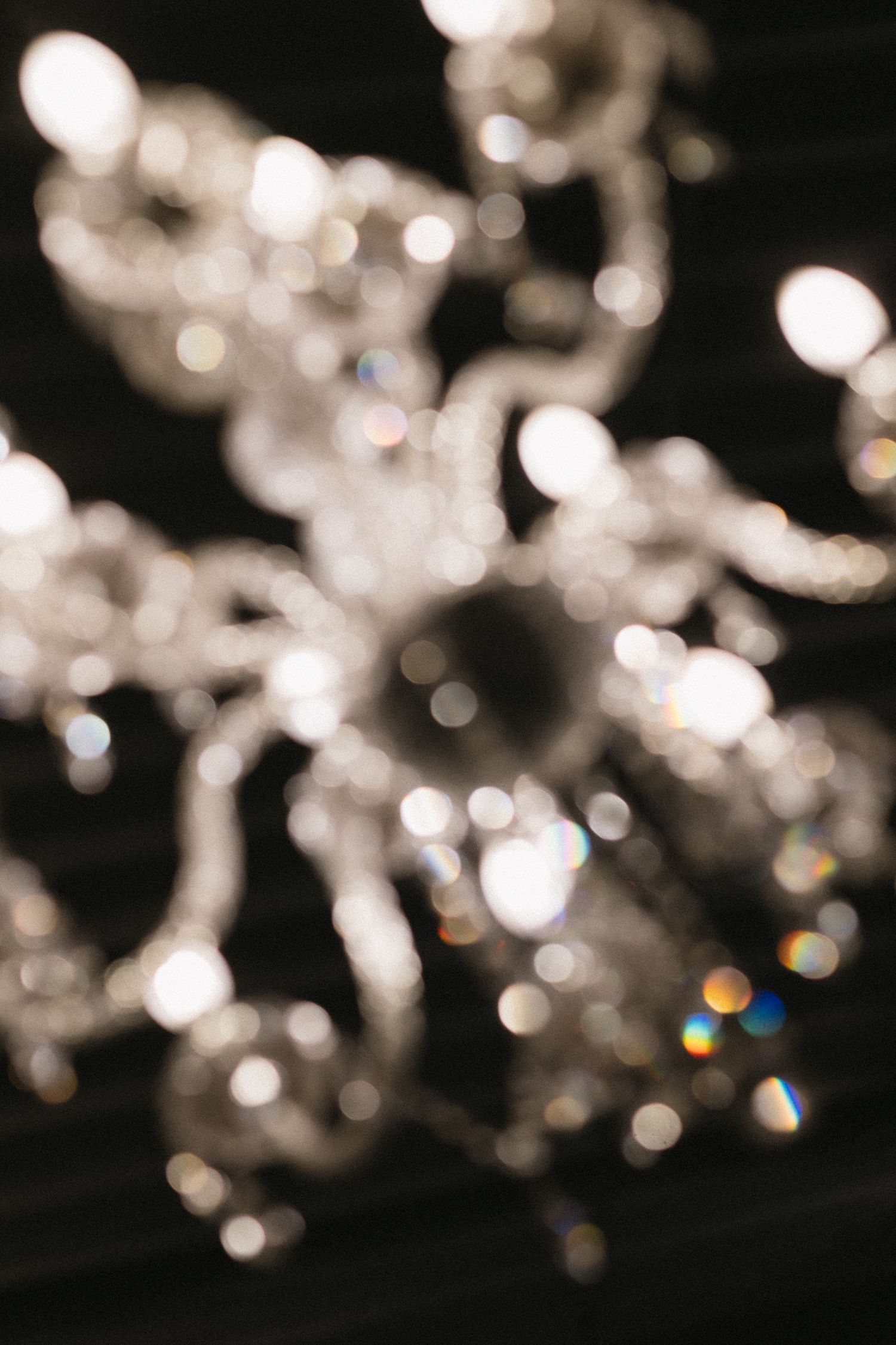Abstract bokeh lights creating a dreamy, blurred effect in black and white.
