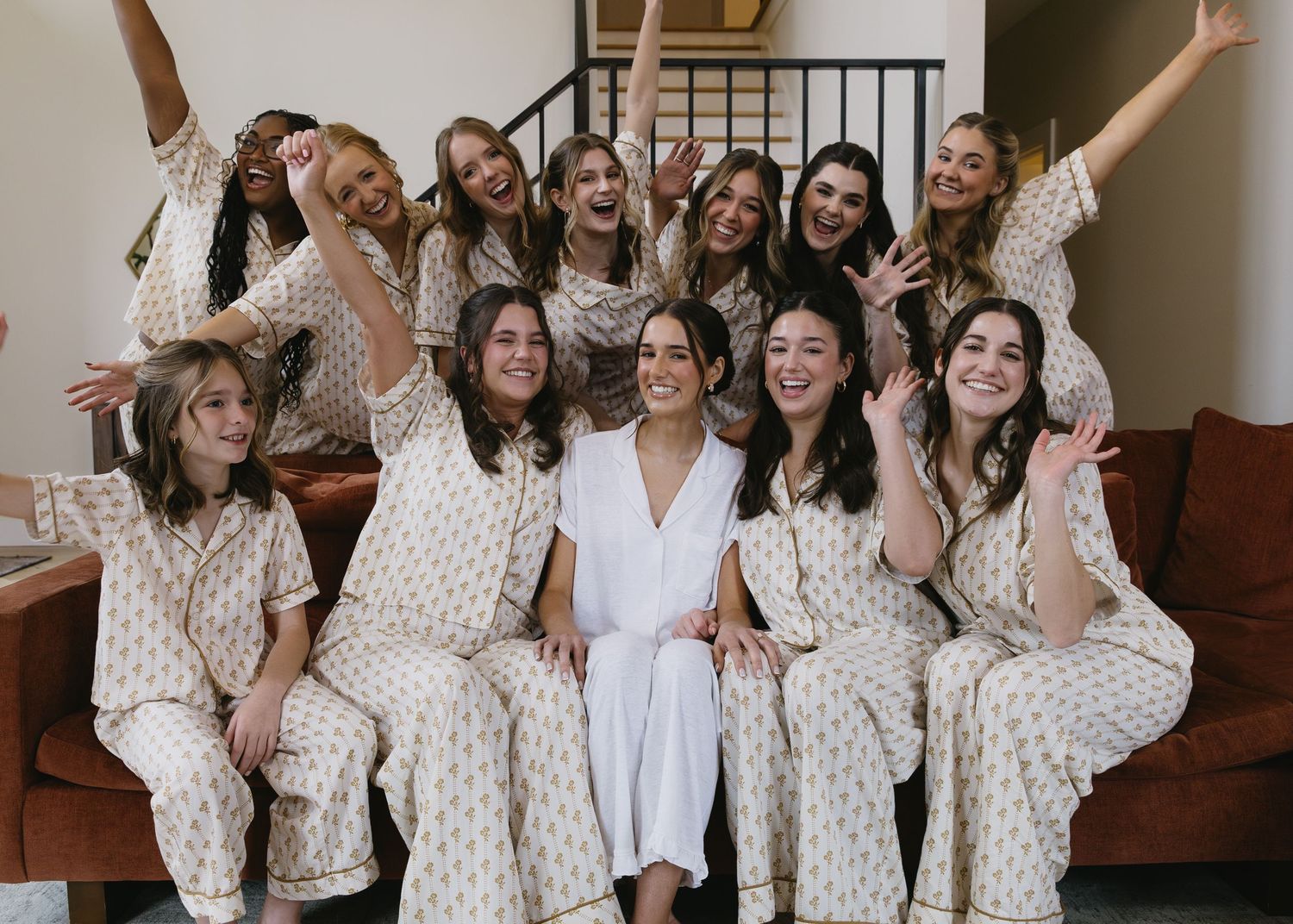 A group celebration shot with bridesmaids in matching patterned robes.
