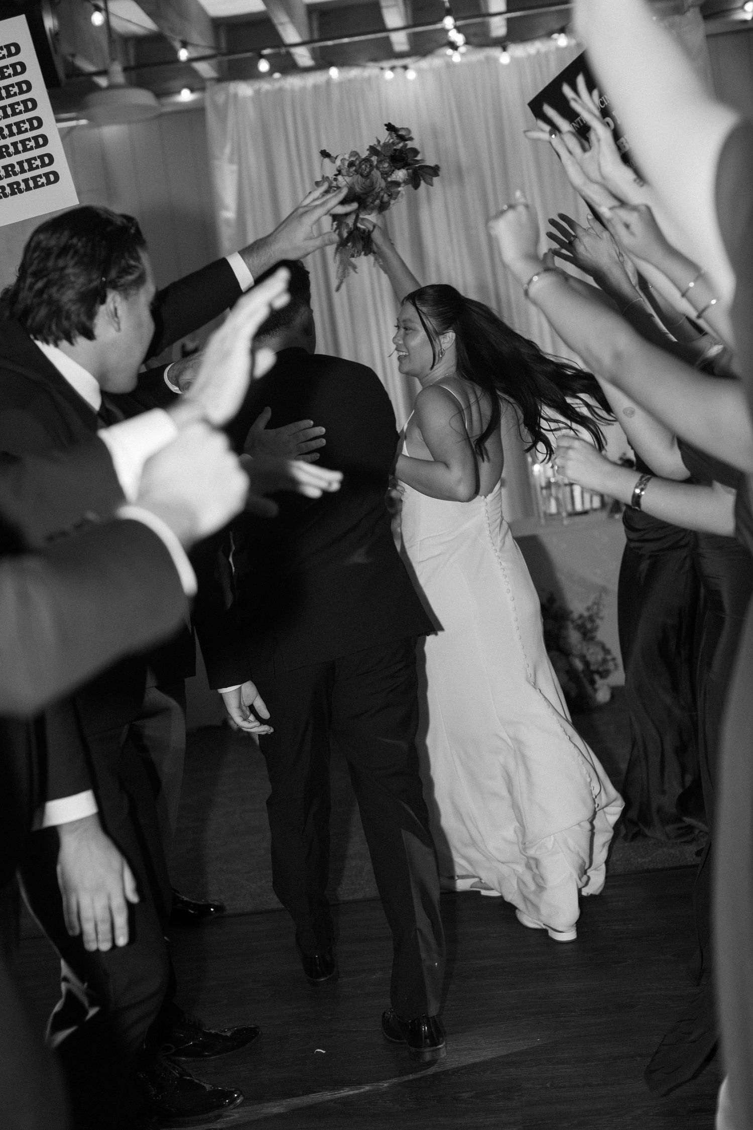 Wedding reception dance floor filled with energy as guests celebrate with the bride.