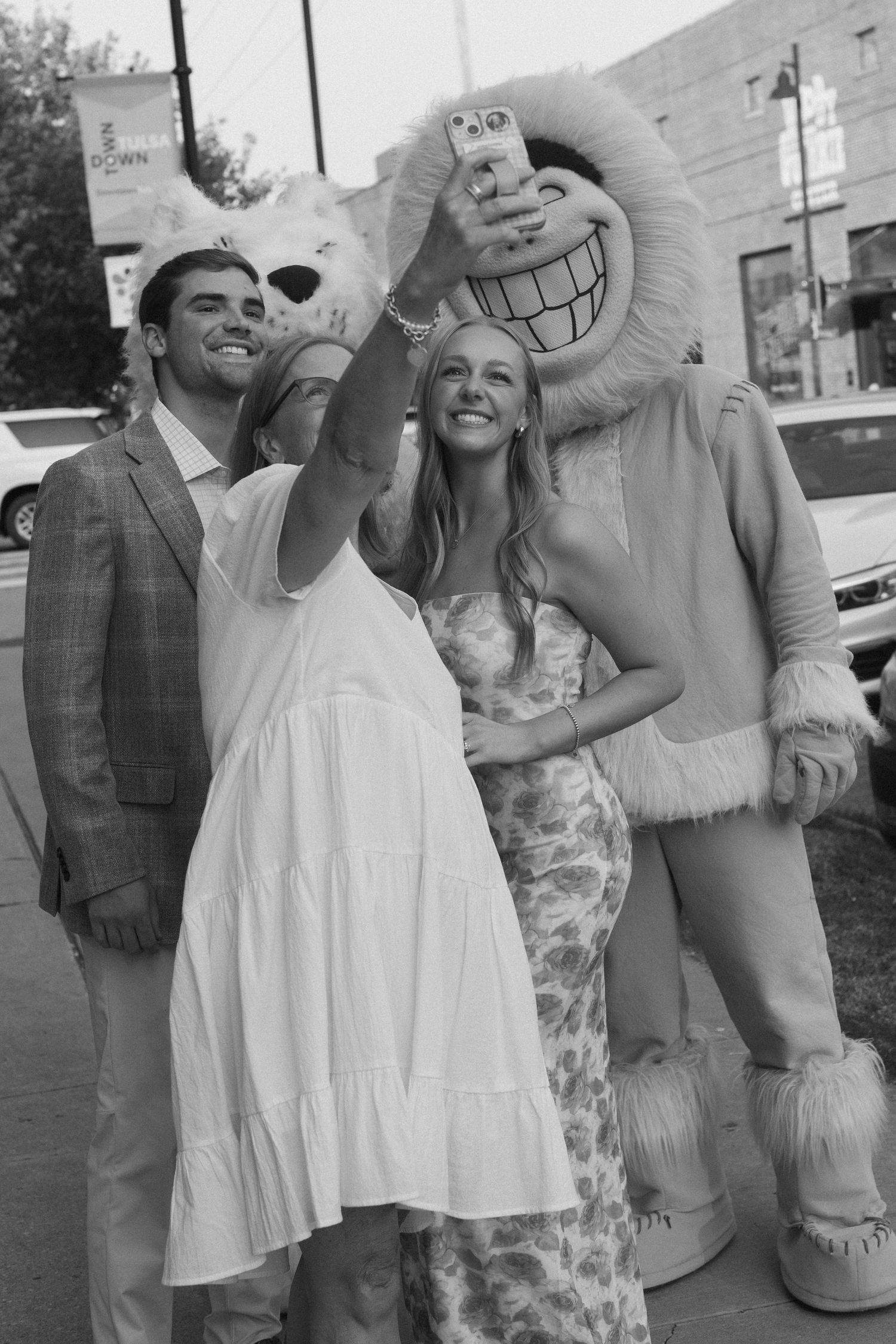 Candid black and white photos showing joyful moments at an outdoor celebration.