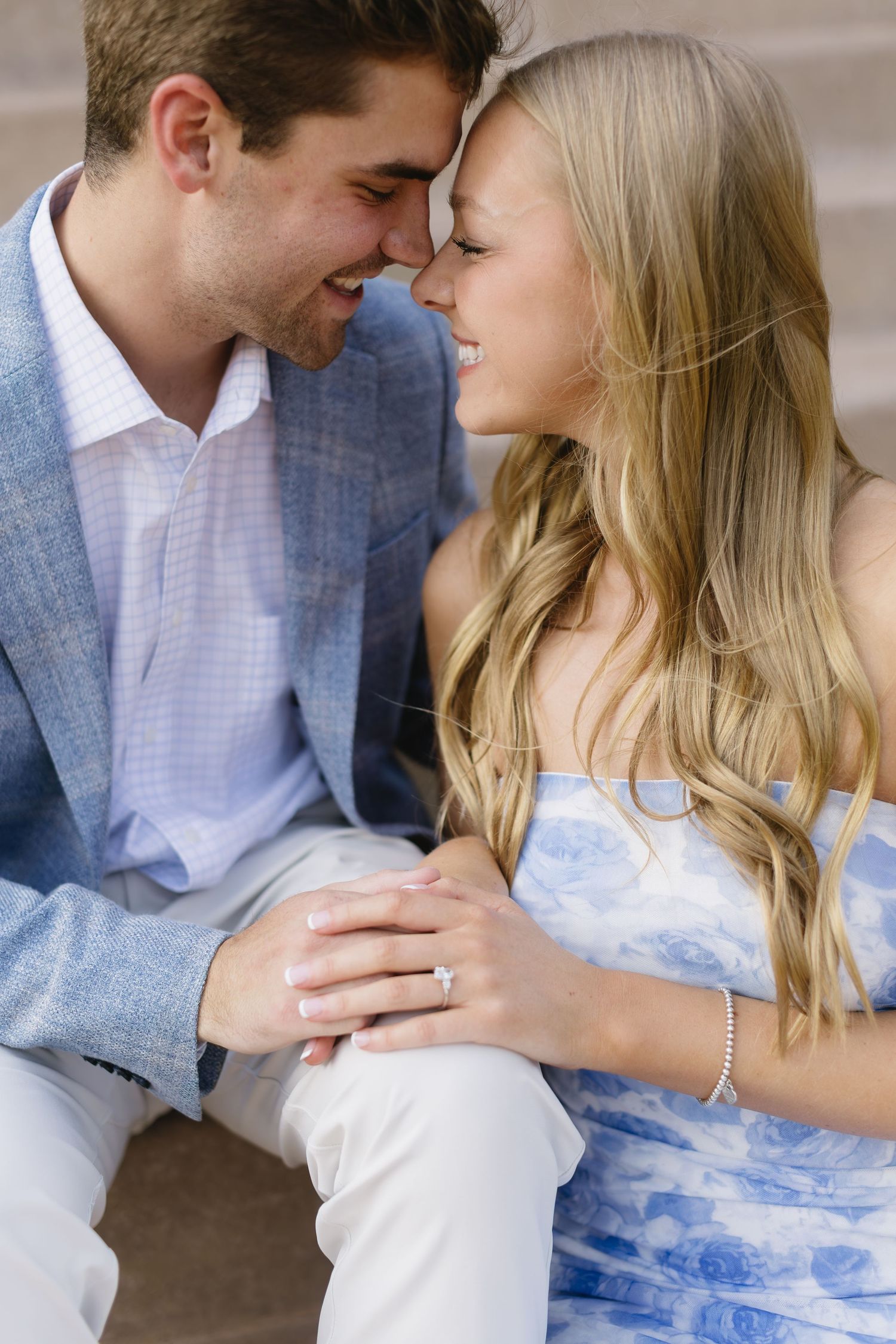 Couple sharing an intimate romantic moment in matching light blue and white attire.