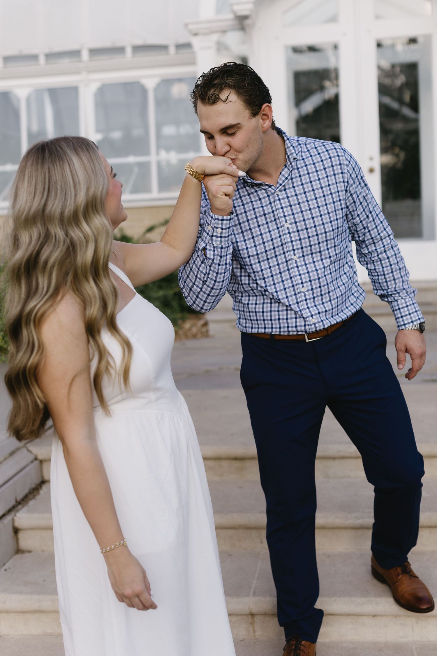 Dancing and twirling on a terrace with white columns creates a playful photo sequence.