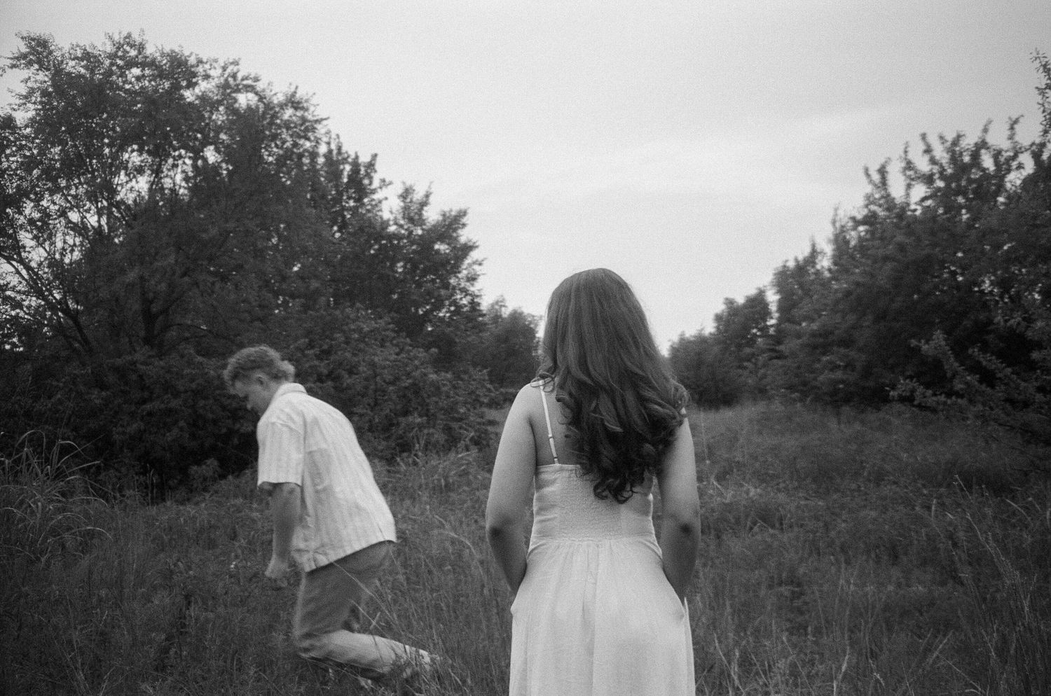 A sequence of film stills showing figures in a meadow during what appears to be a wedding or ceremony.
