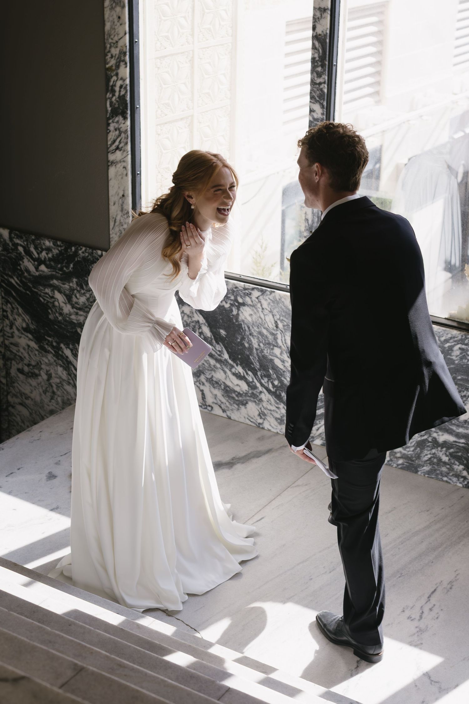 A series of intimate wedding photos showing a couple in a sunlit room with marble walls.
