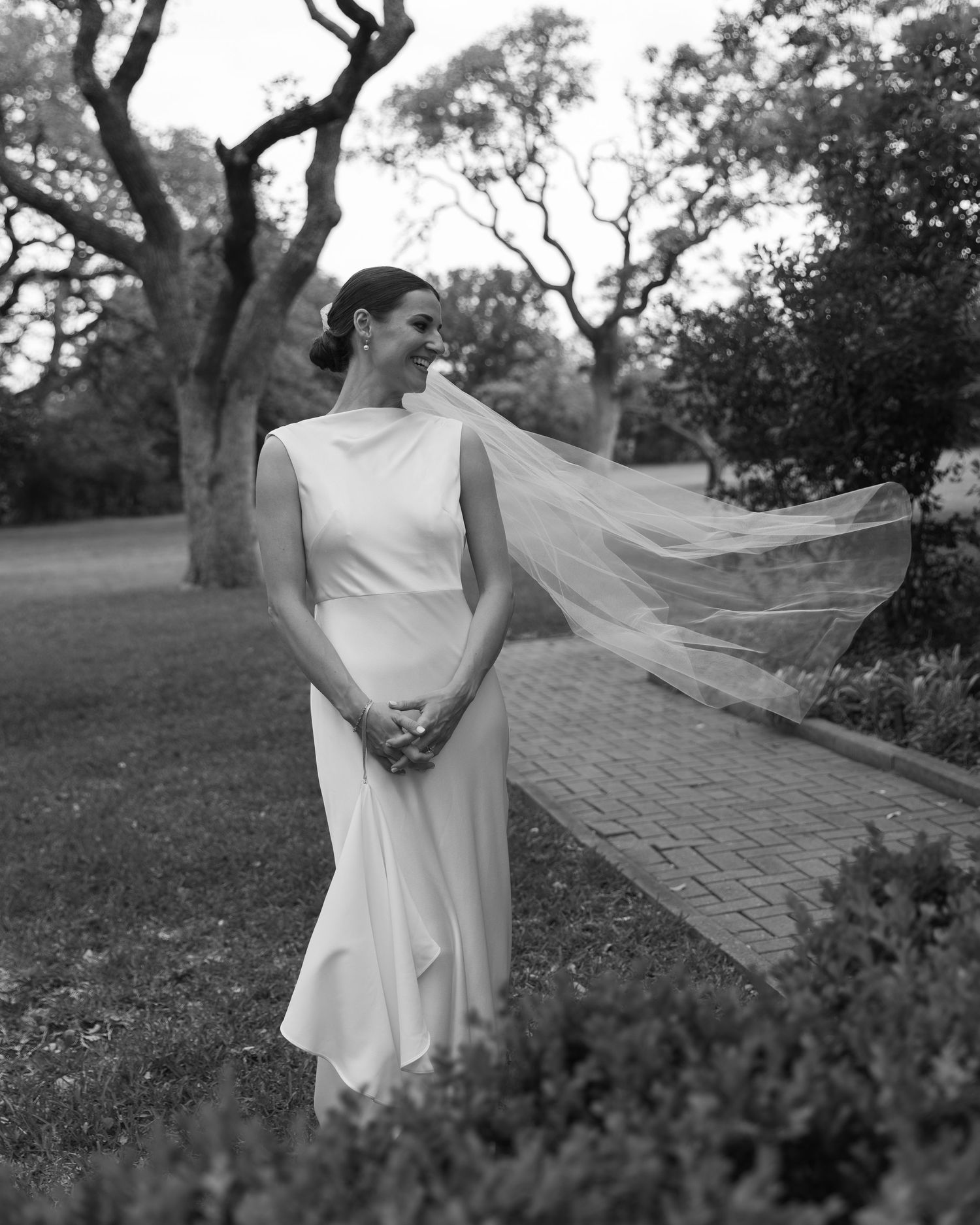 Black and white bridal portrait sequence showing flowing veil movement against a scenic outdoor backdrop.