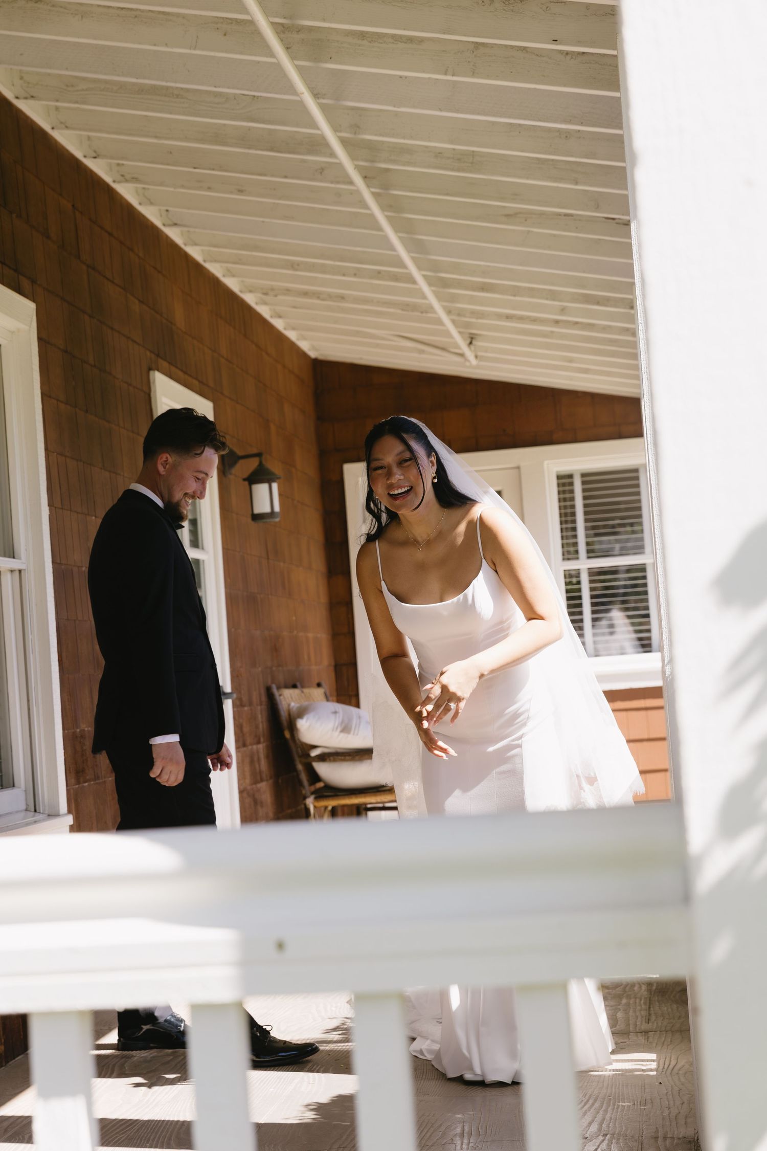 Candid sequence of wedding couple walking on a covered porch.