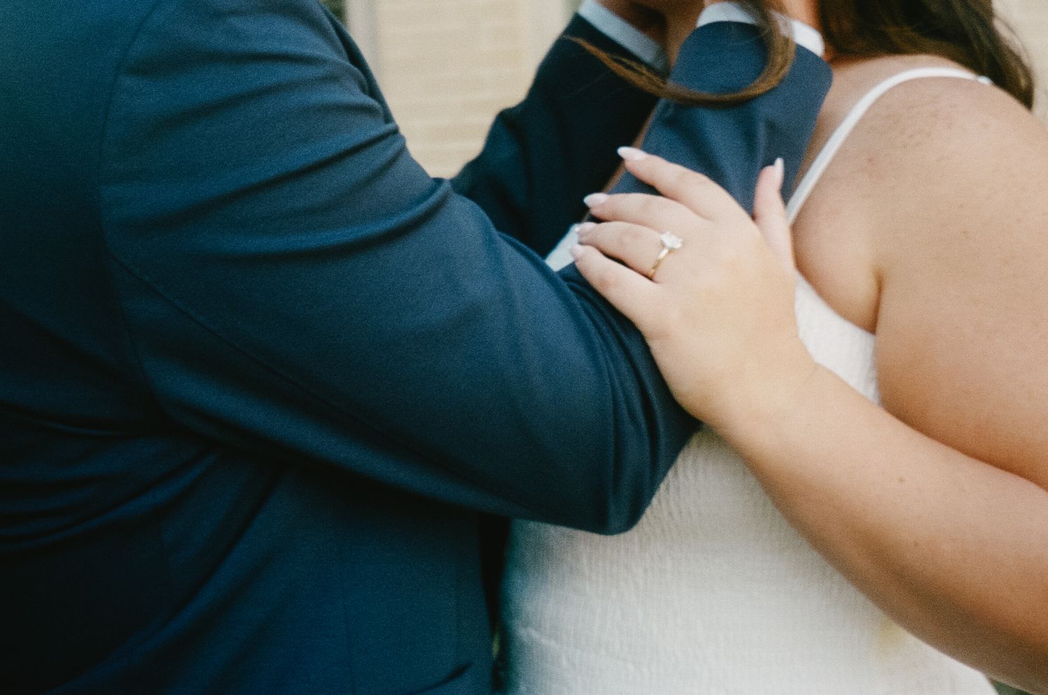 A couple in formal attire shares a romantic dance together at a wedding reception.