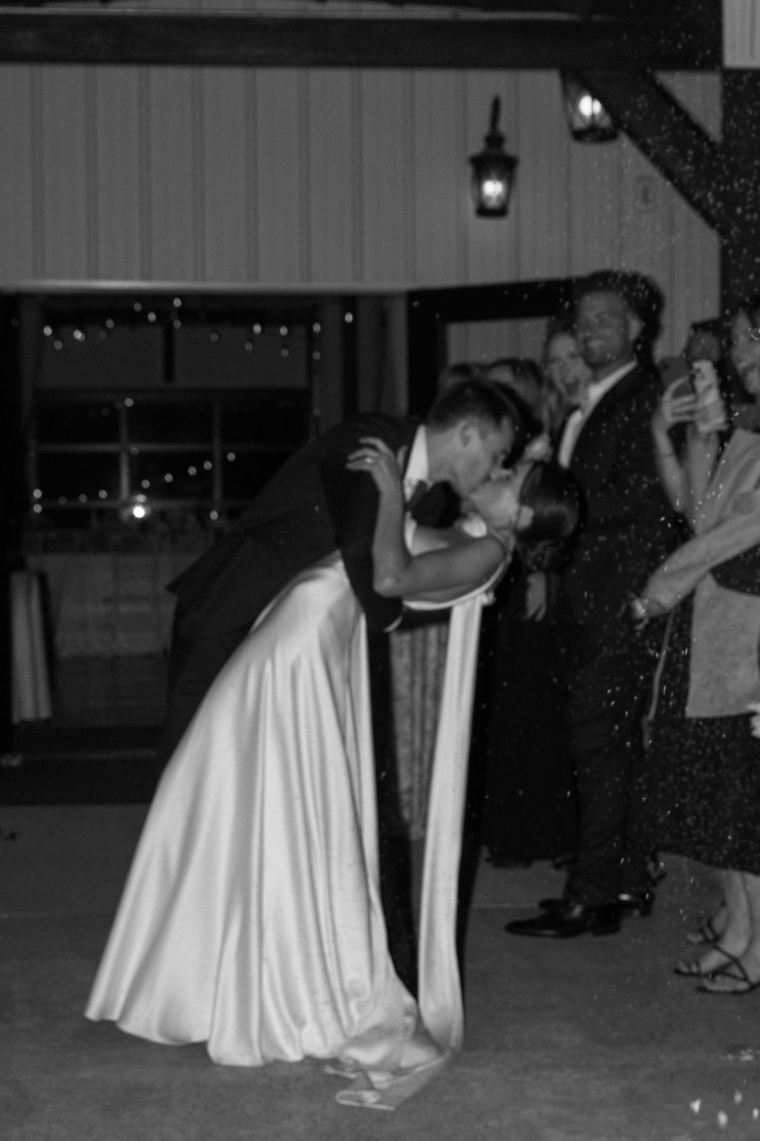 Wedding couple dancing in formal attire during their reception celebration.
