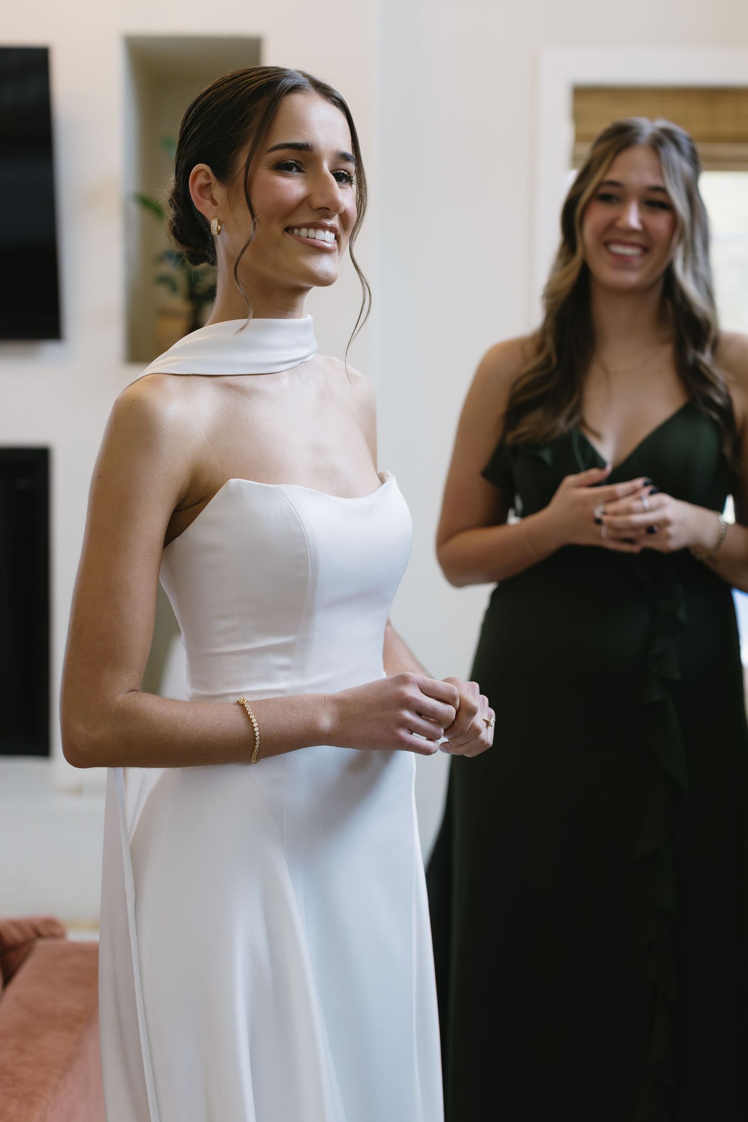 A wedding preparation scene showing elegant white bridal gown alongside dark formal attire.