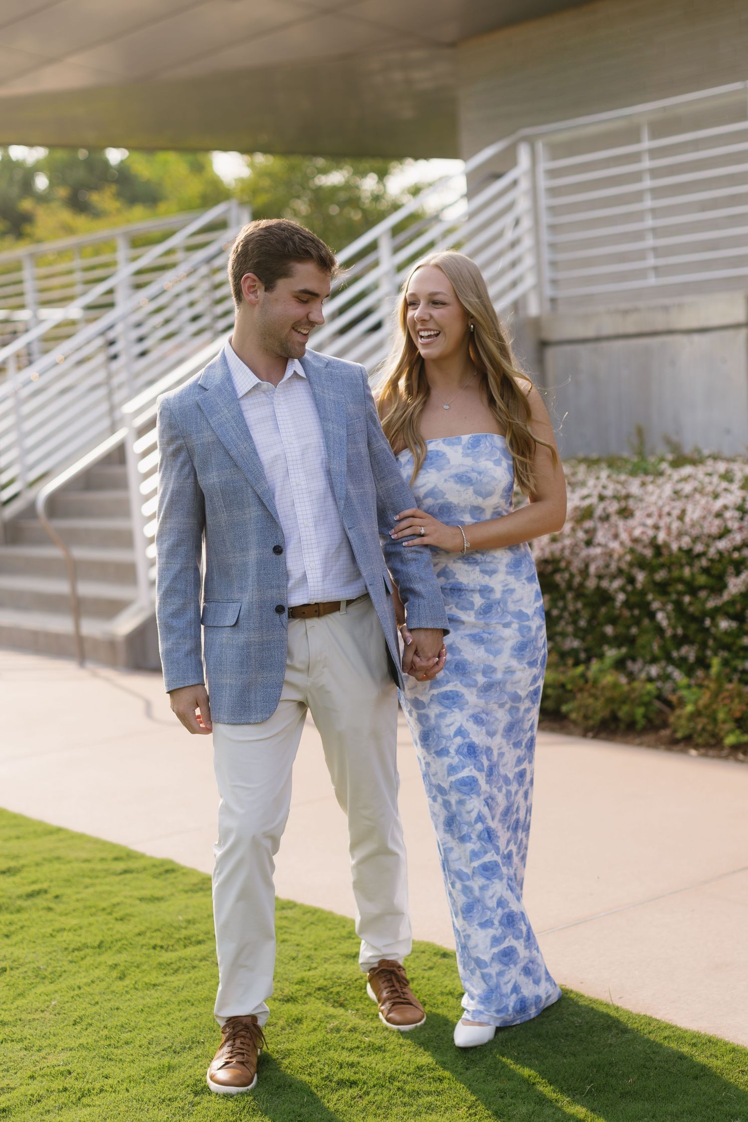 Couple walking together outdoors, wearing coordinating blue and white summer outfits.