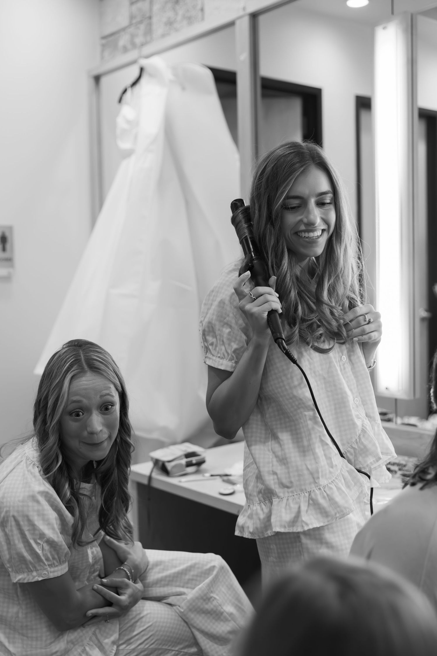 Black and white sequence of bridal preparation candid moments in a dressing room.