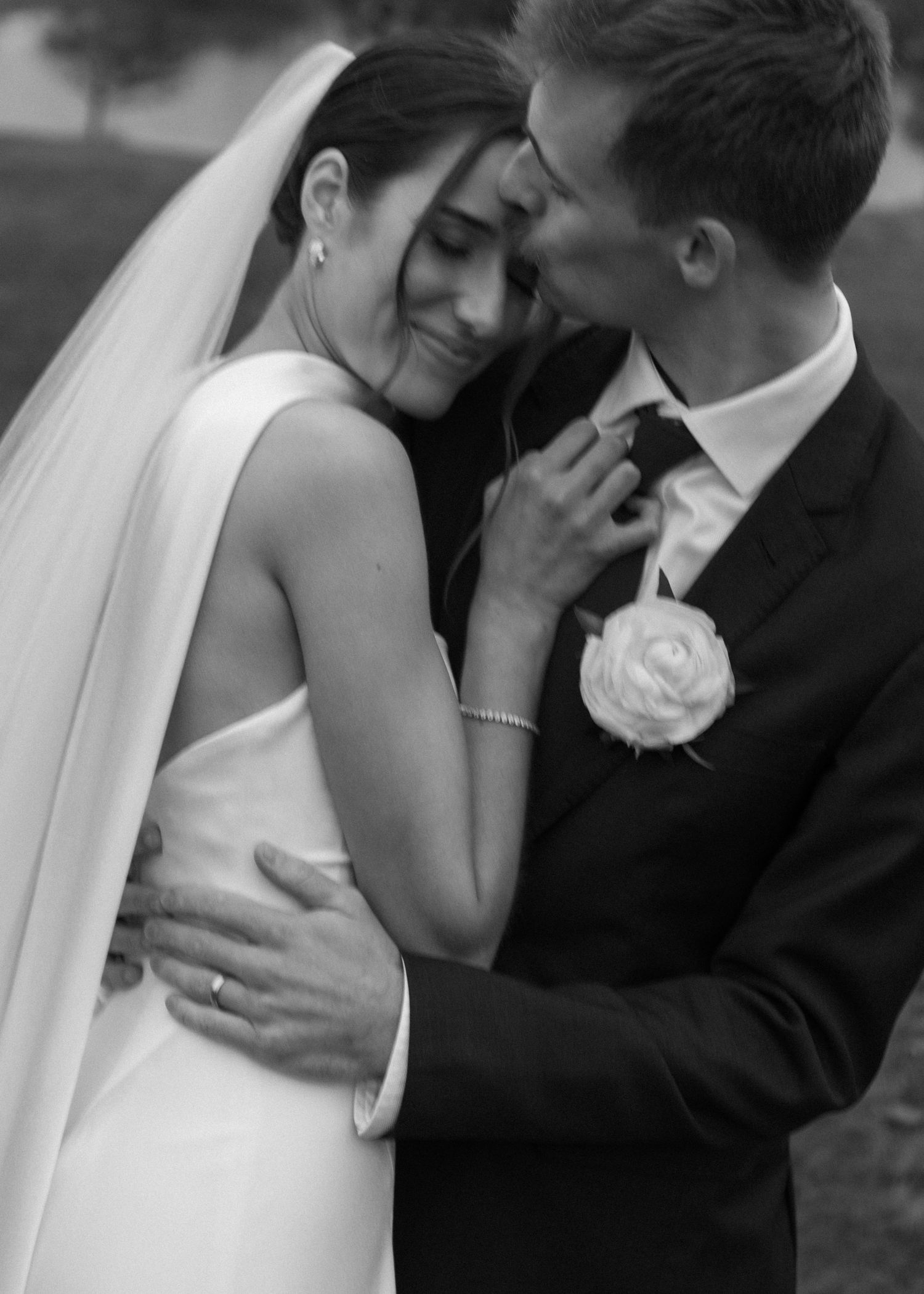 Series of romantic black and white wedding photos capturing intimate embraces between newlyweds.