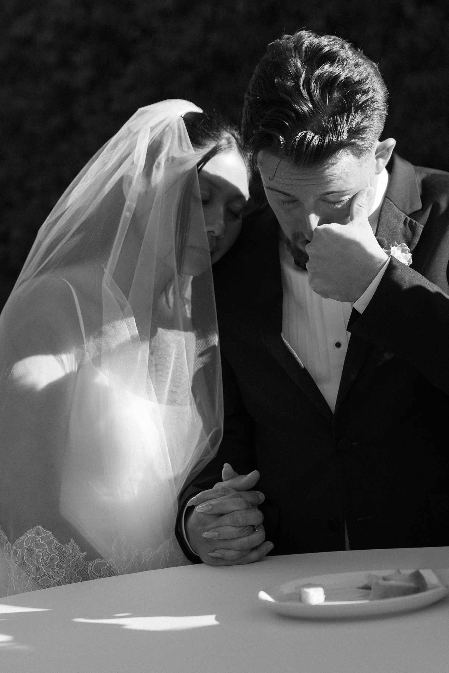 An intimate black and white moment between newlyweds during their wedding ceremony.