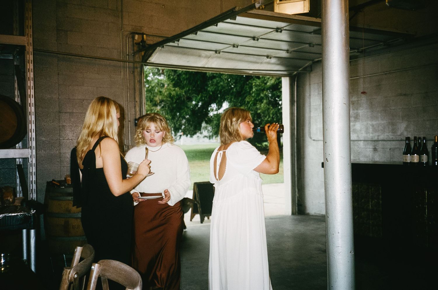 Industrial-style venue interior with concrete walls and metal support columns.
