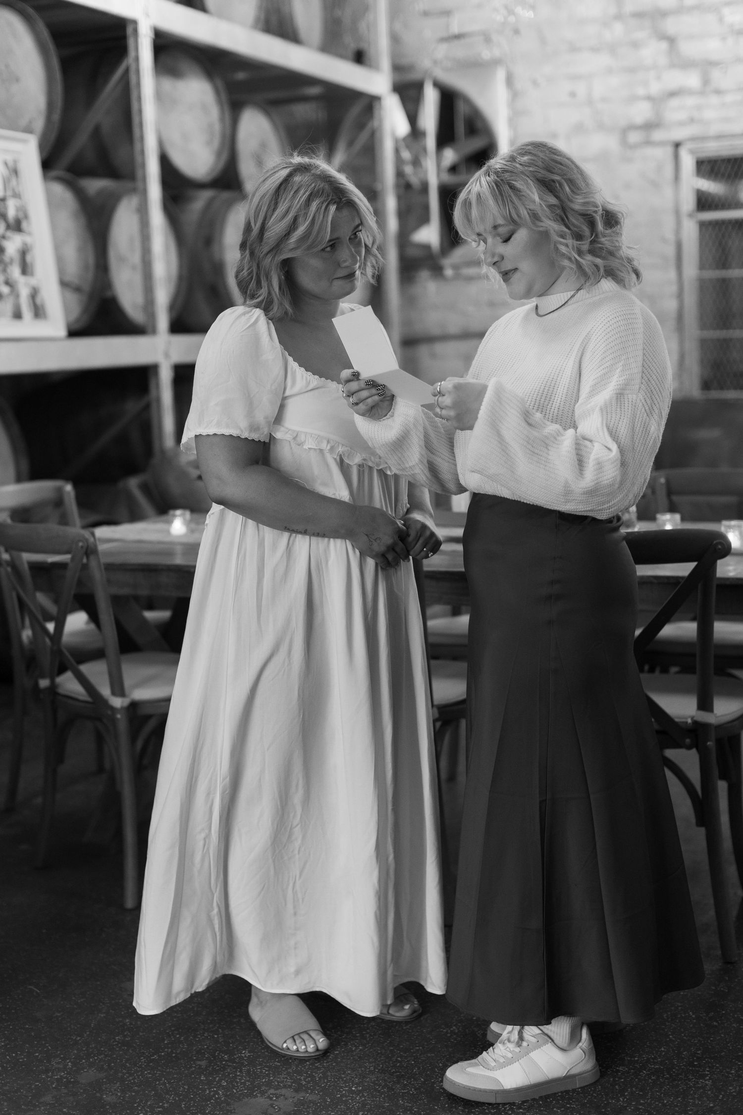 Two people in contrasting black and white outfits share an intimate moment during a dance.