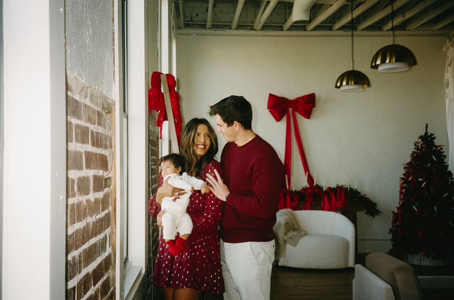 A series of four connected holiday photos showing festive decorations and people in red sweaters celebrating indoors.