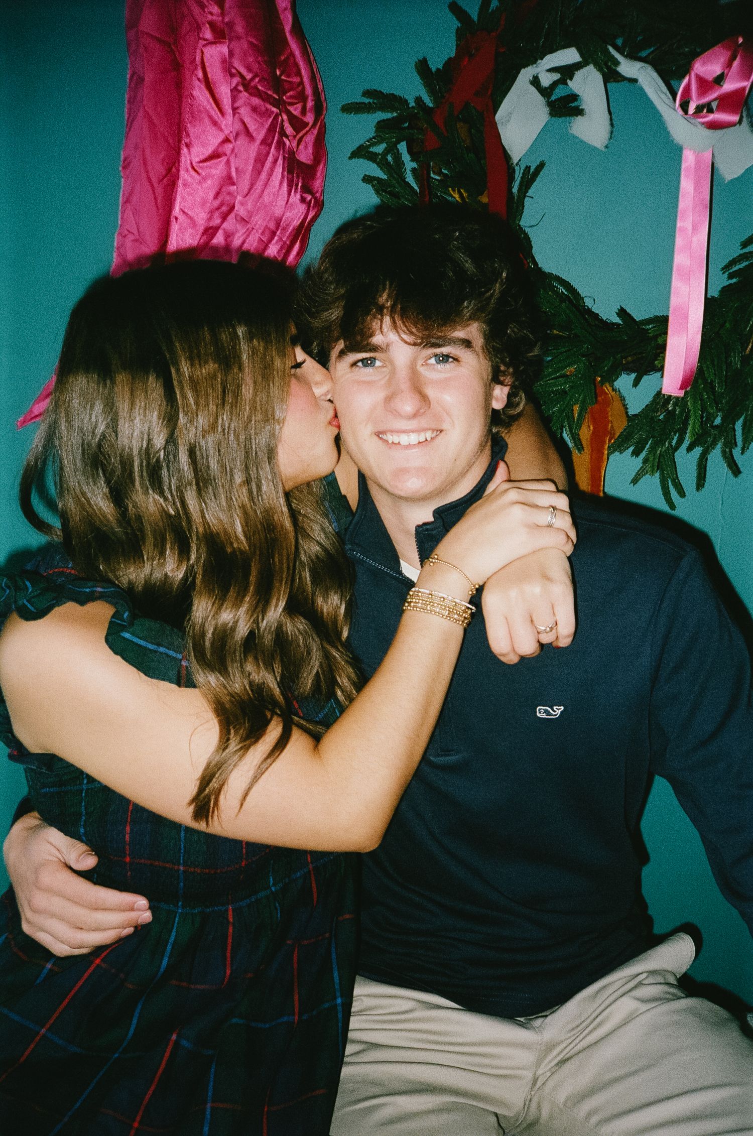 A series of playful photo booth style shots showing a couple in a romantic moment against a teal background.