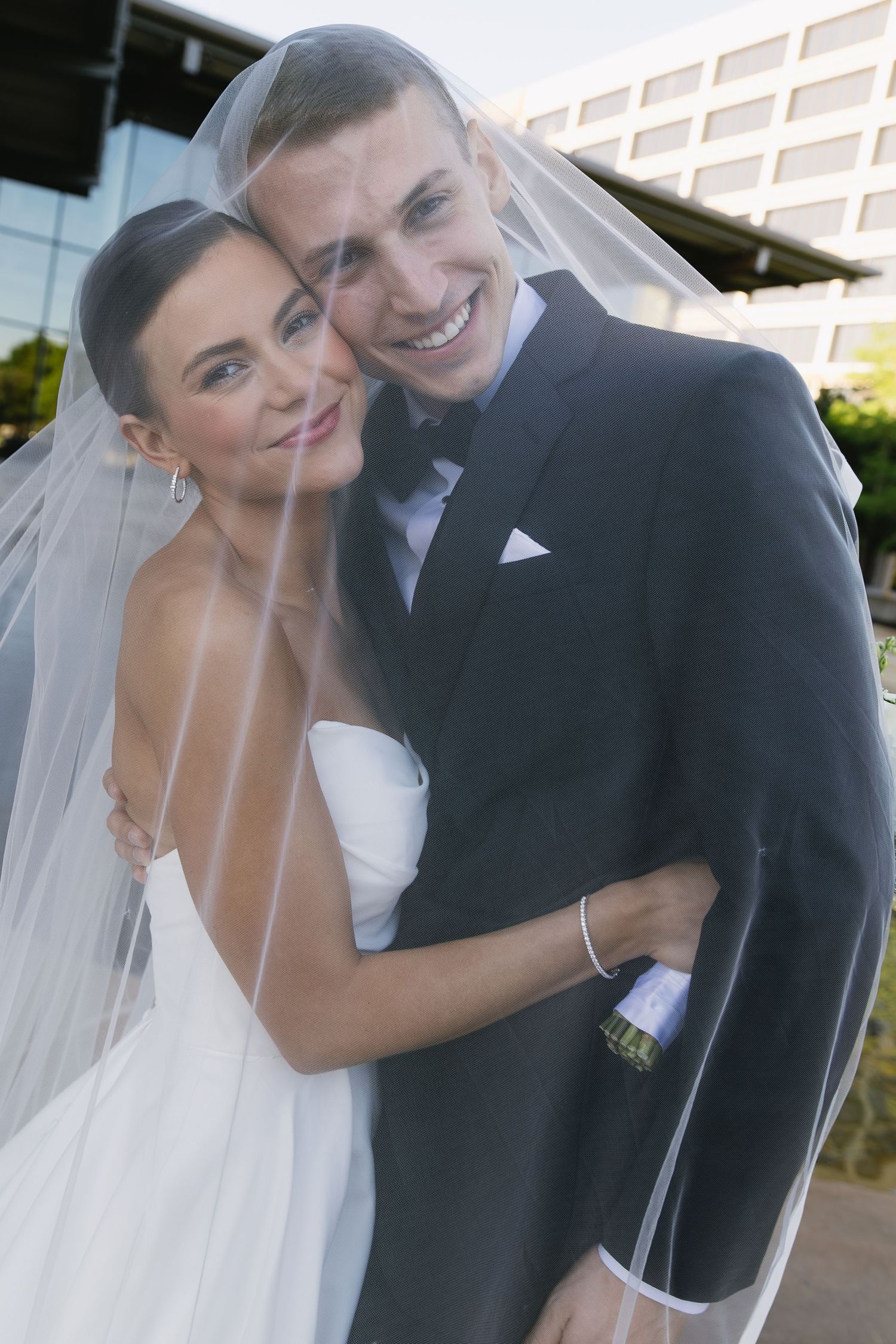Romantic wedding couple embraces in a series of candid outdoor portraits.