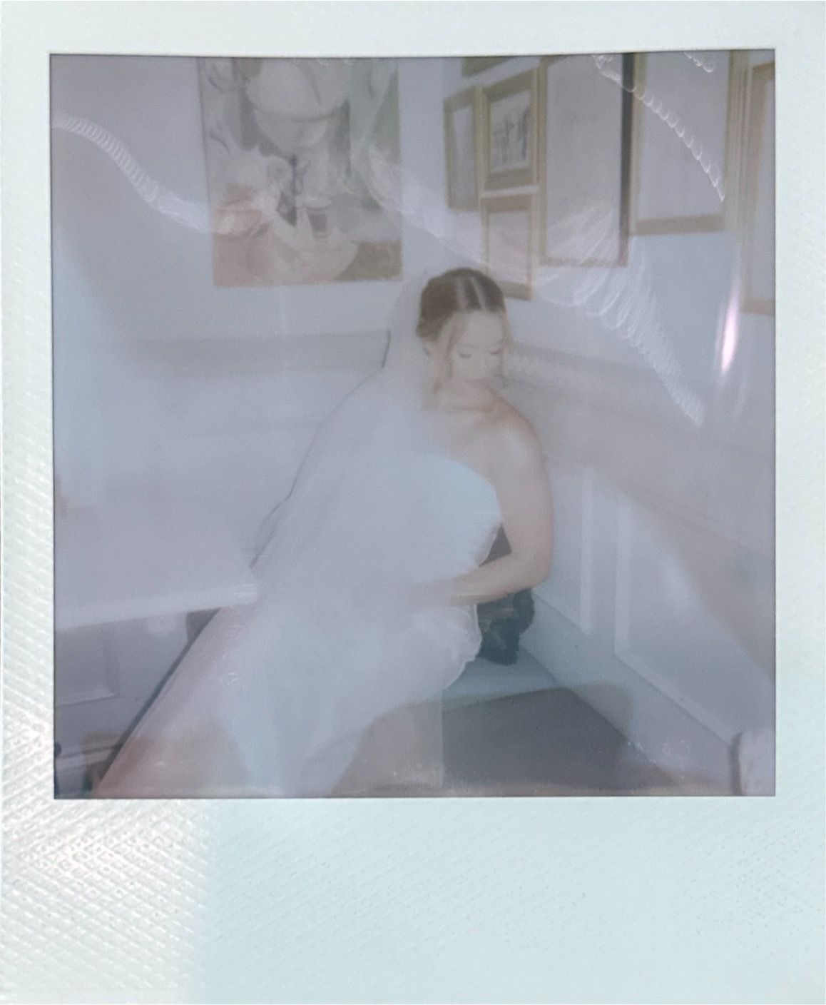 A soft ethereal double exposure photo creates a dreamy atmosphere with white fabric and light streaming through a window.